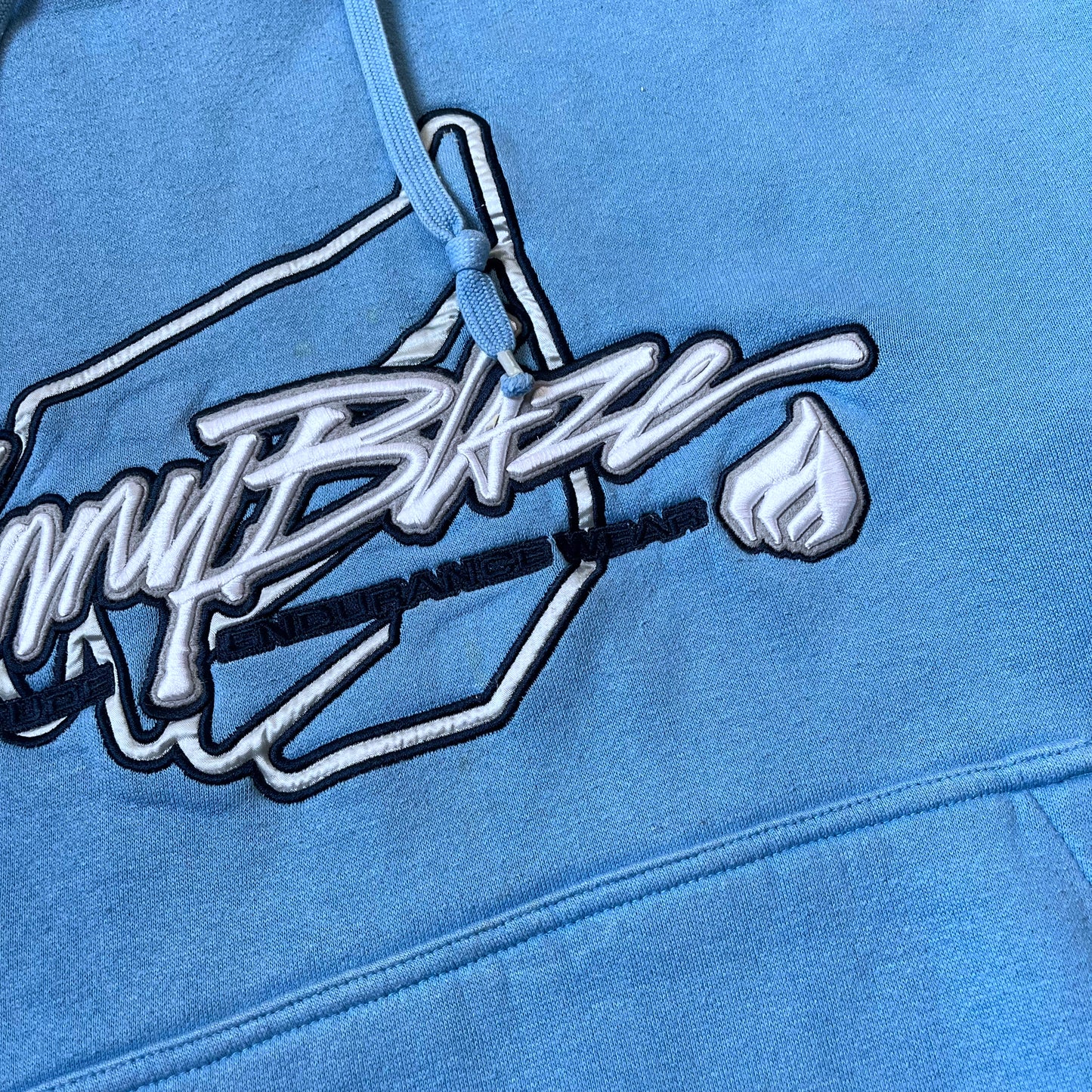 Close up of stitching on Johnny Blaze 3D embroidered spell out on a vintage 90s men's blue hoodie.