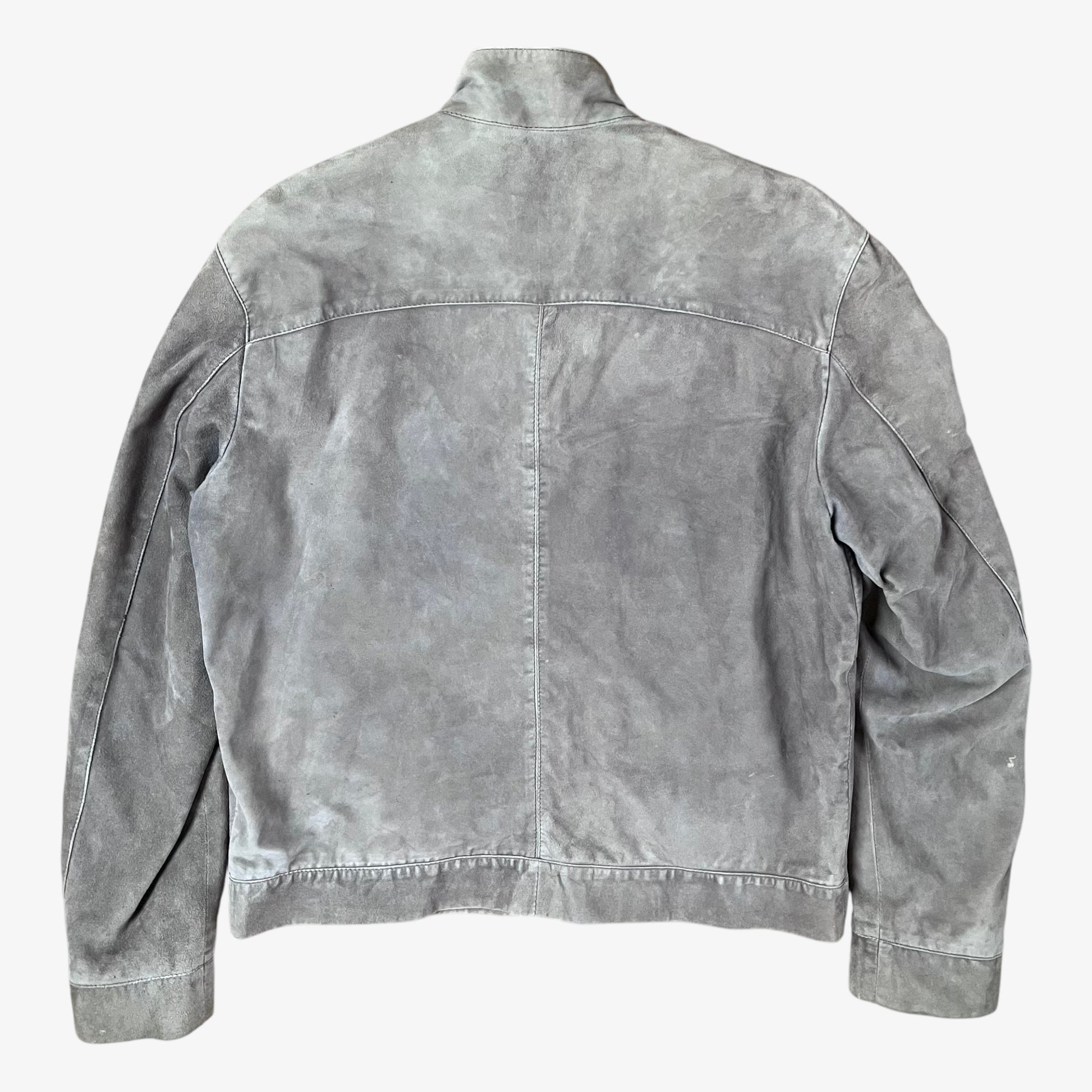 Back of vintage 90s Just Cavalli men’s faded beige leather jacket with multiple front pockets, engraved zips, and motorcycle-inspired style.