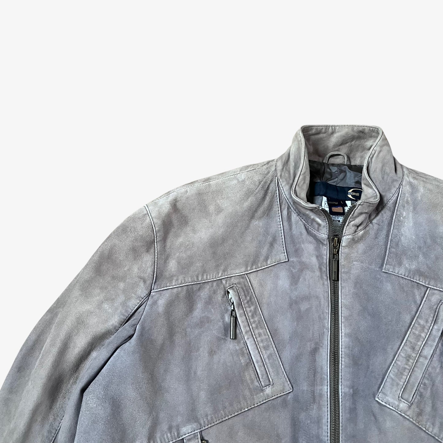 Close up of vintage 90s Just Cavalli men’s faded beige leather jacket with multiple front pockets and engraved zips.