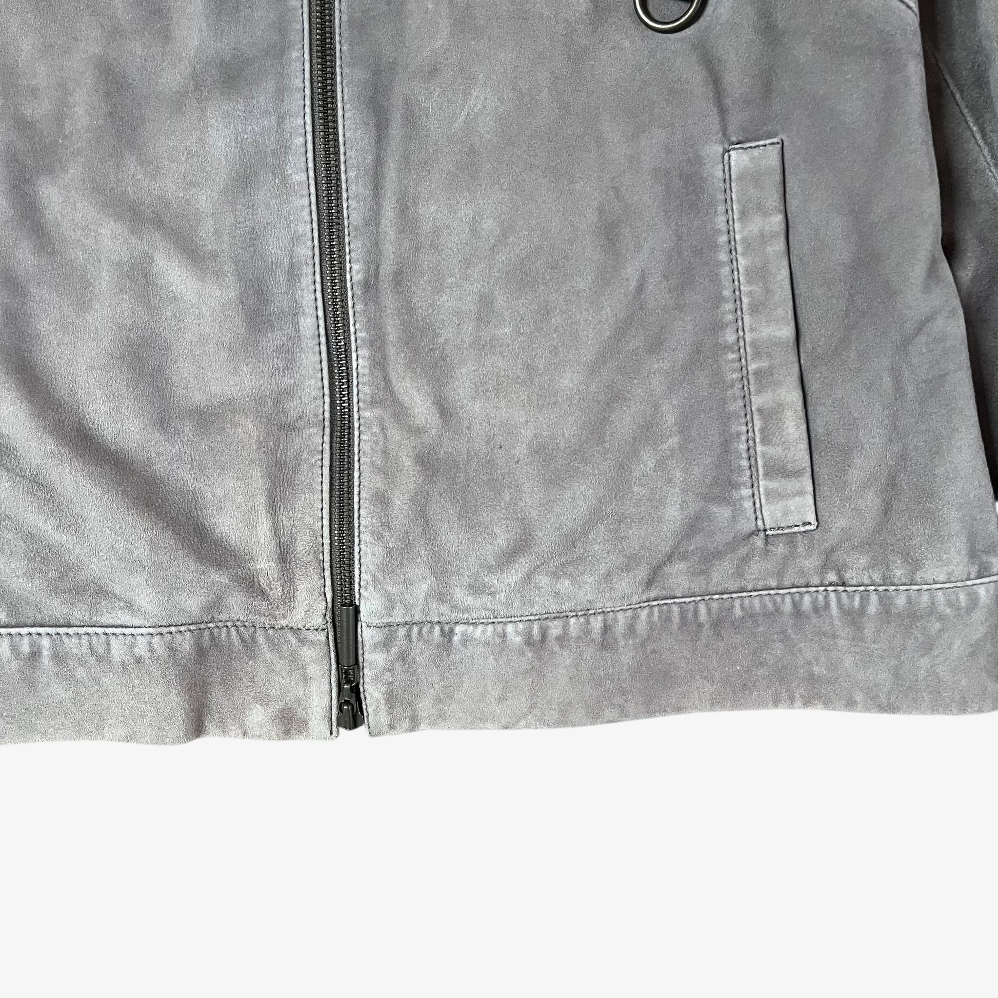 Hem of vintage 90s Just Cavalli men’s faded beige leather jacket.