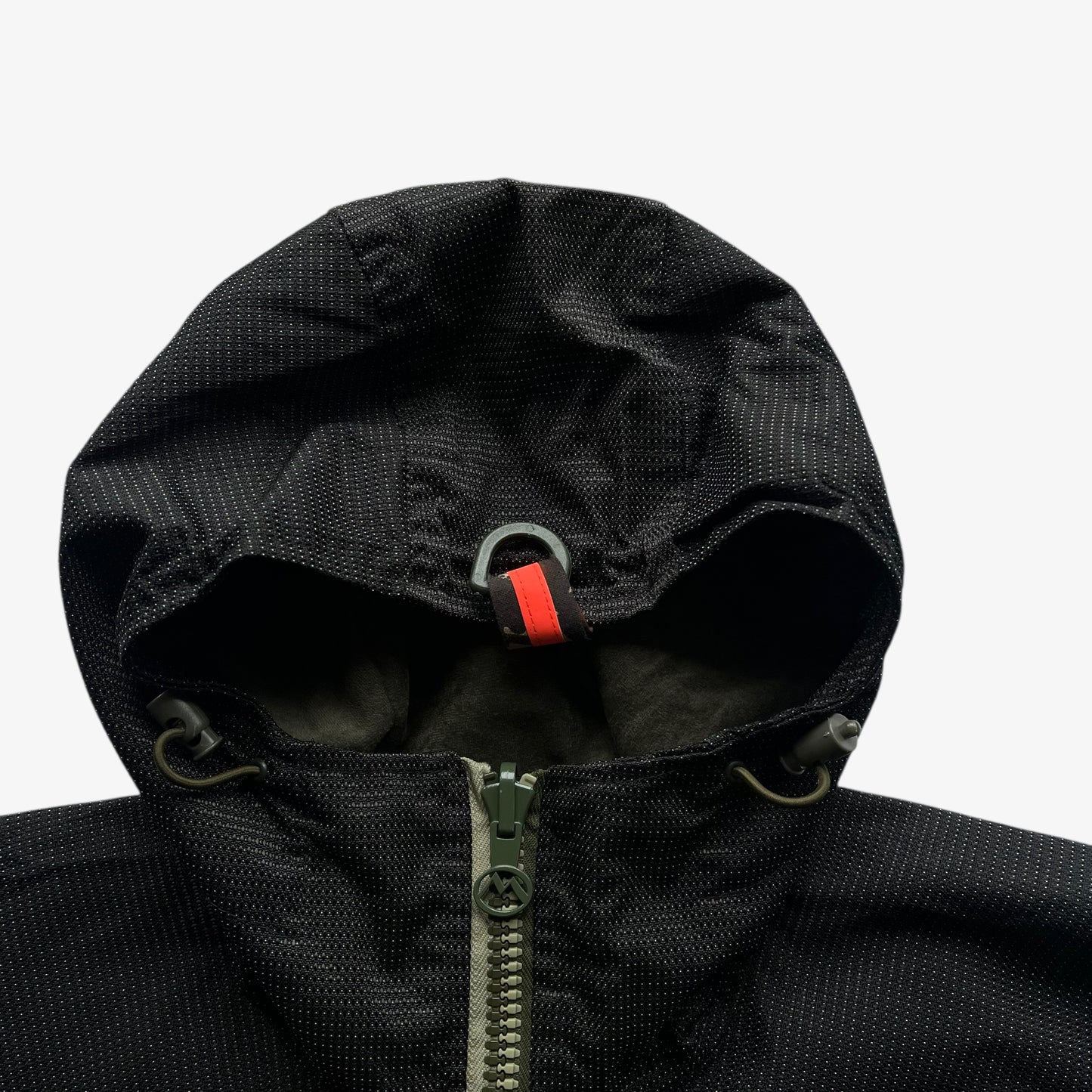 Black 3M Scotchlite reflective hood of a vintage Maharishi jacket on a white background.