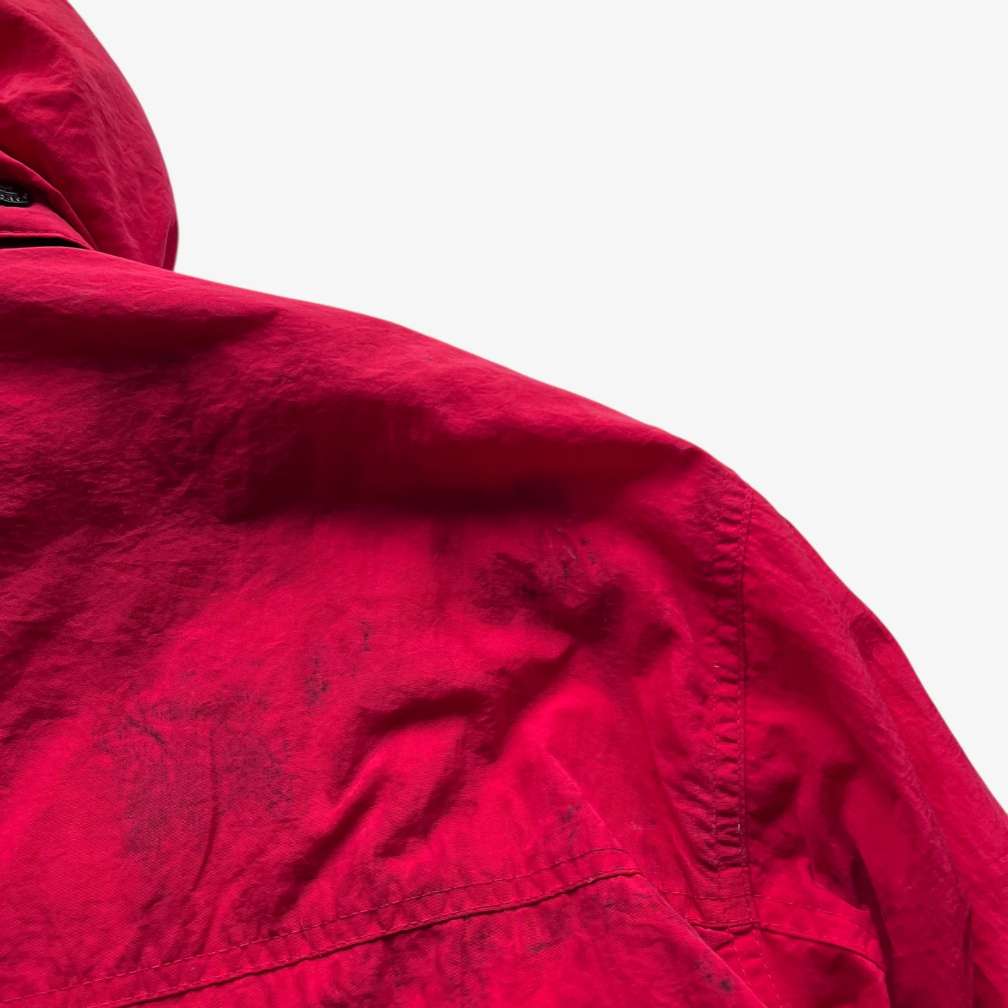 Patina on the back of vintage 90s men's Marlboro country store red hooded puffer jacket.