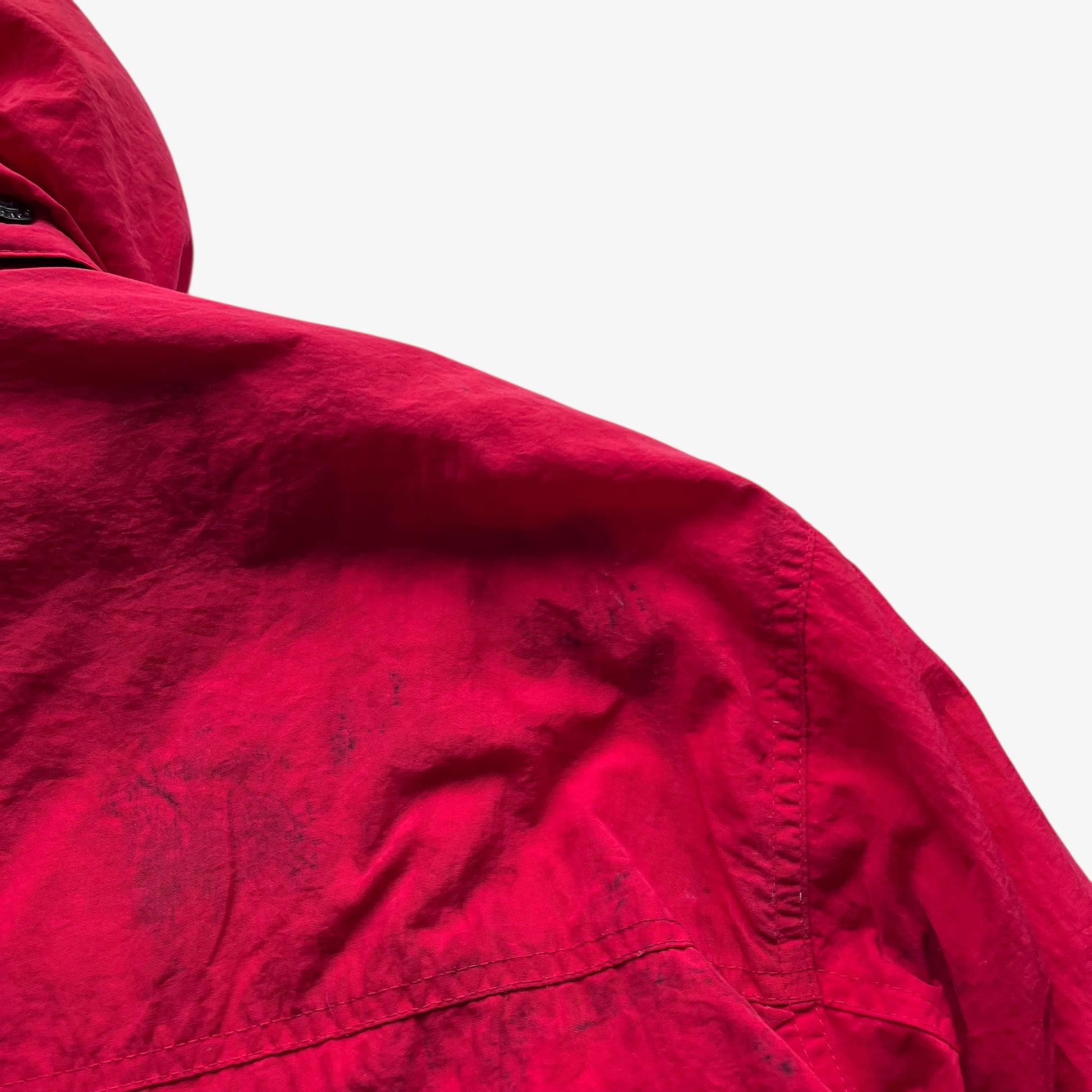 Patina on the back of vintage 90s men's Marlboro country store red hooded puffer jacket.