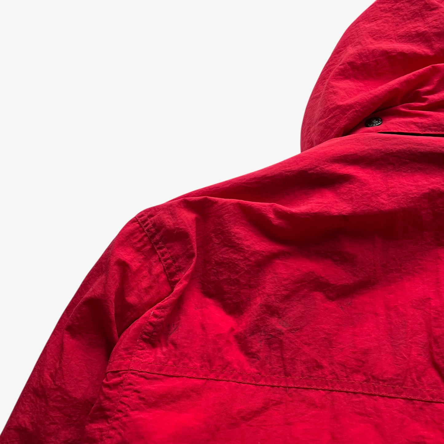 Back wear on vintage 90s men's Marlboro country store red hooded puffer jacket.