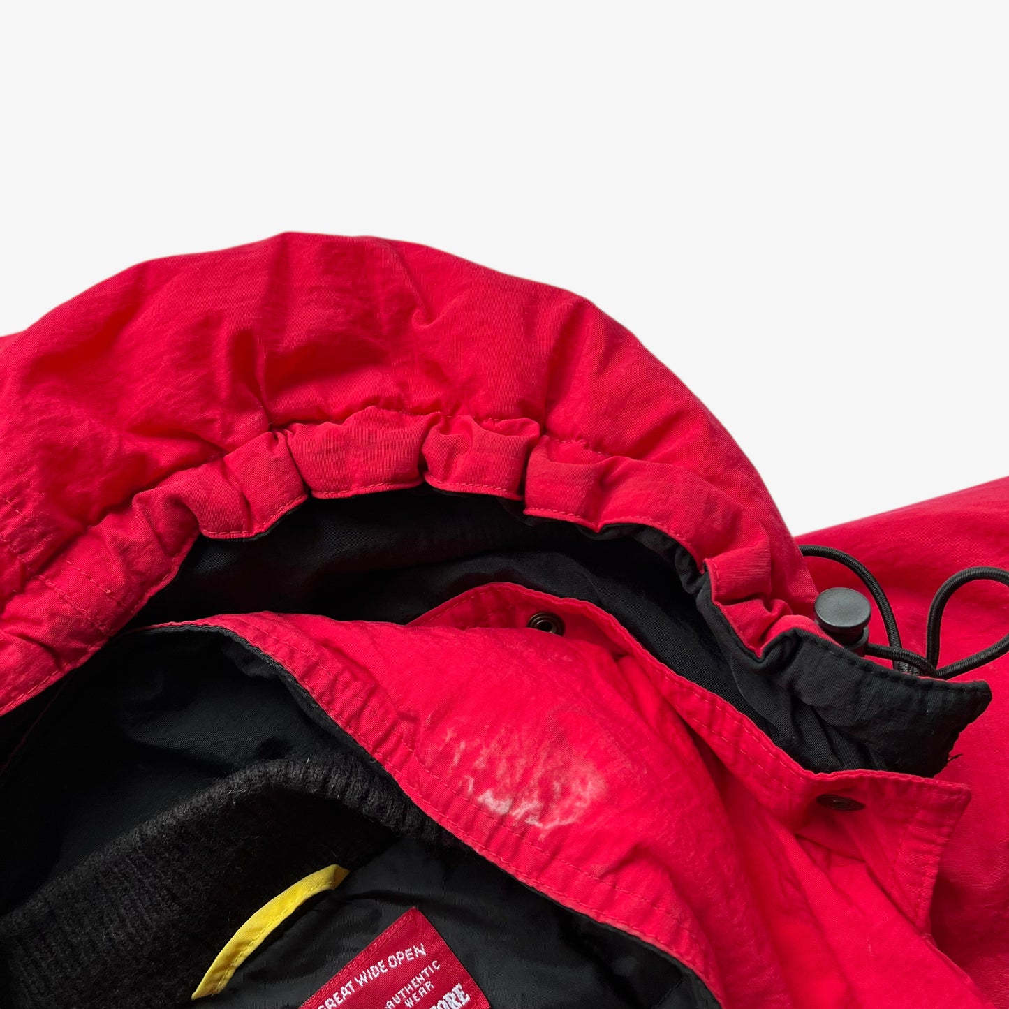 Collar of vintage 90s men's Marlboro country store red hooded puffer jacket.