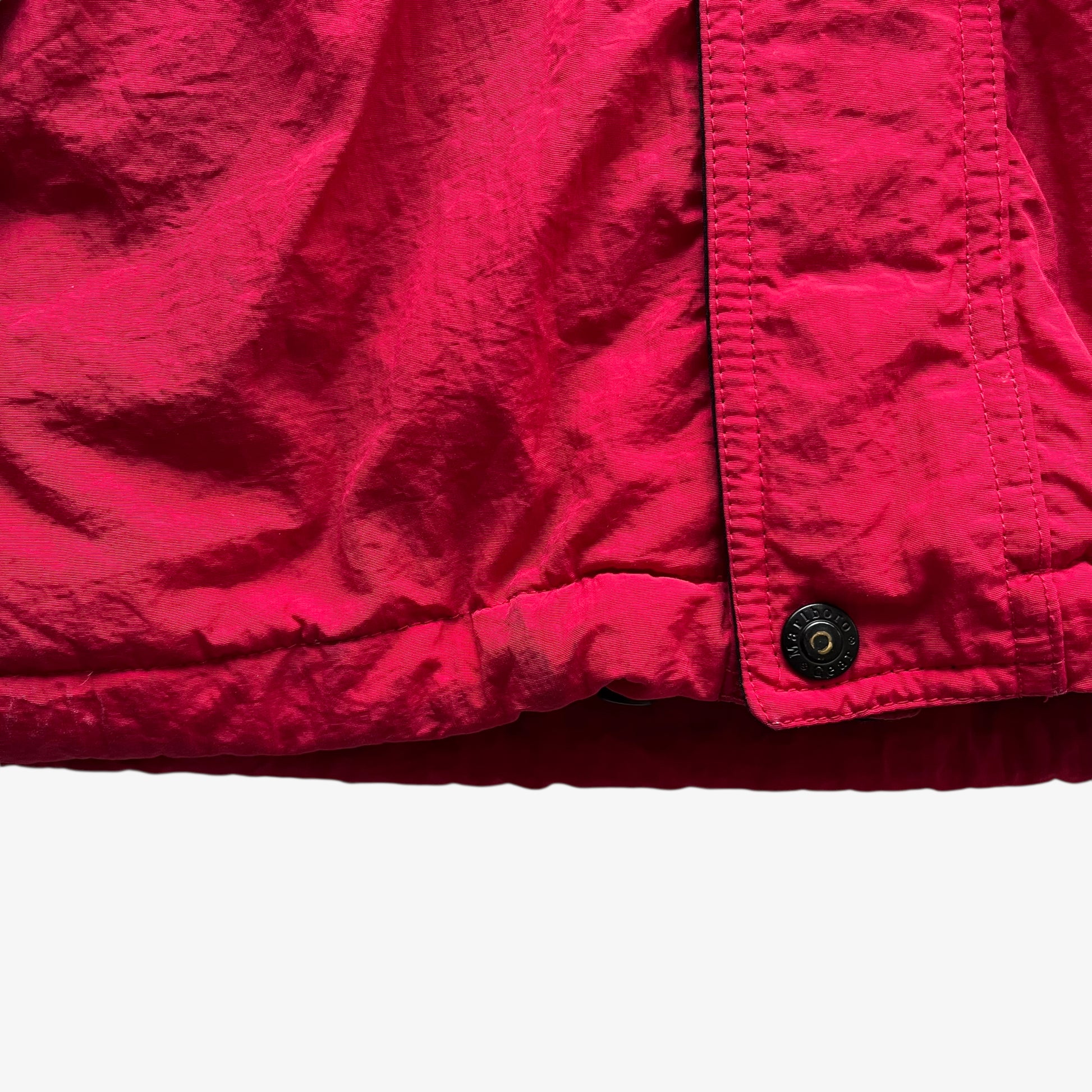 Hem of vintage 90s men's Marlboro country store red hooded puffer jacket.