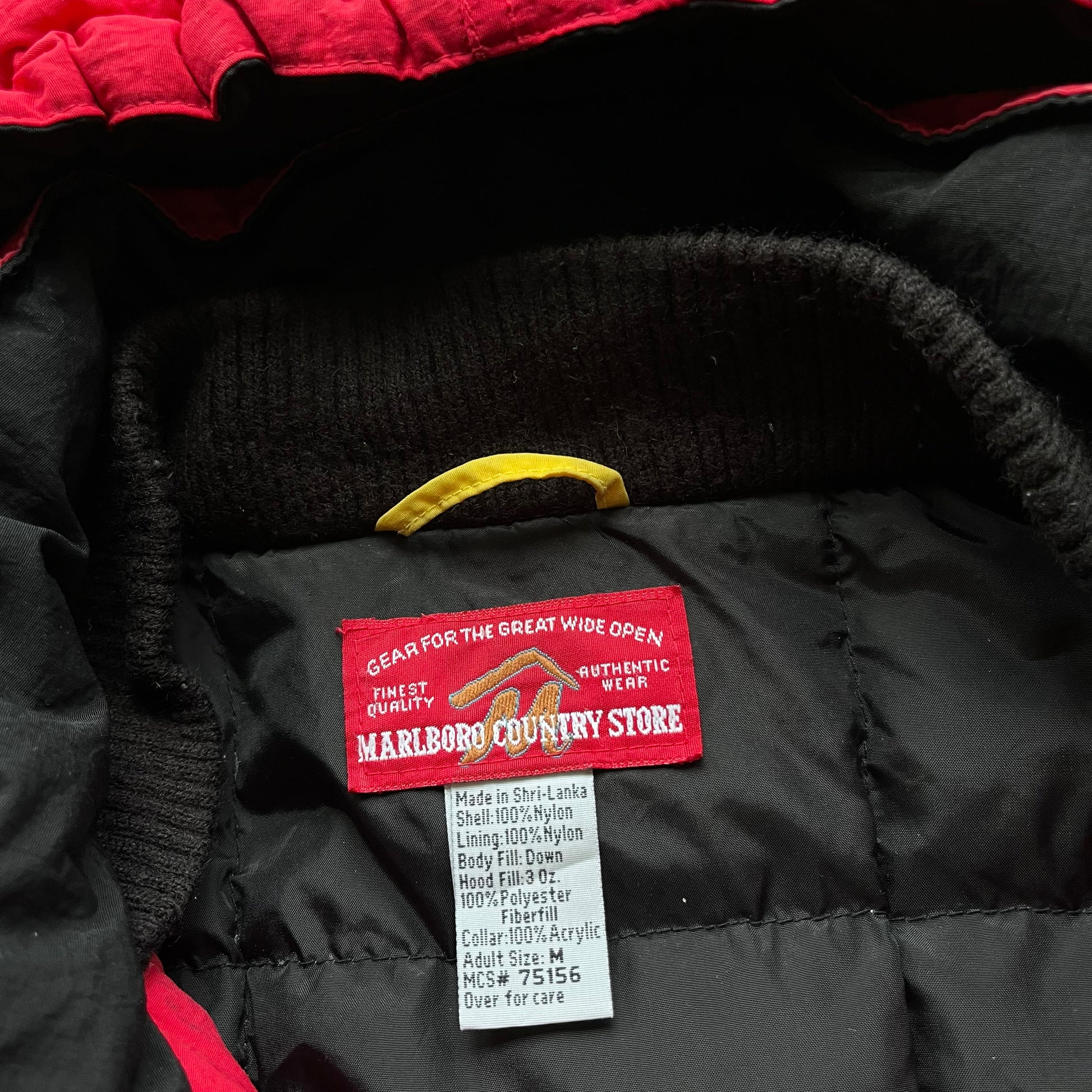 Marlboro country store label stitched inside of vintage 90s men's red hooded puffer jacket.