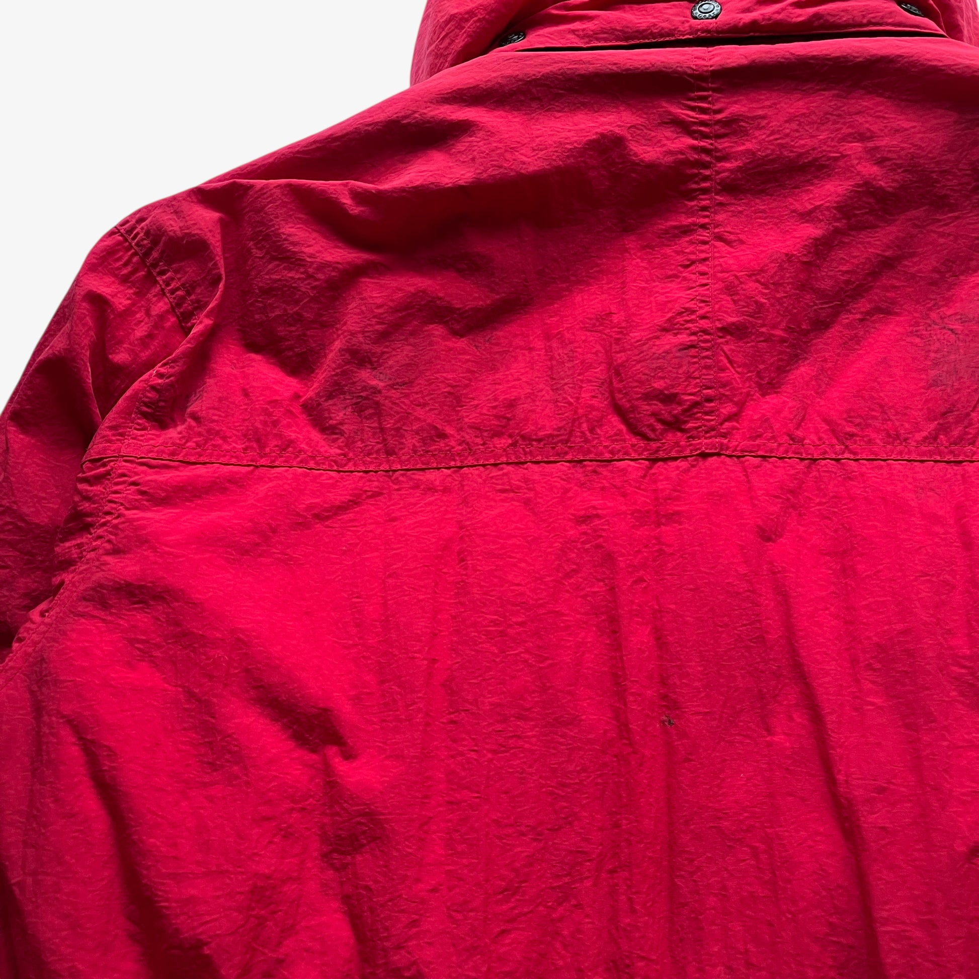 Scuffs on vintage 90s men's Marlboro country store red hooded puffer jacket.
