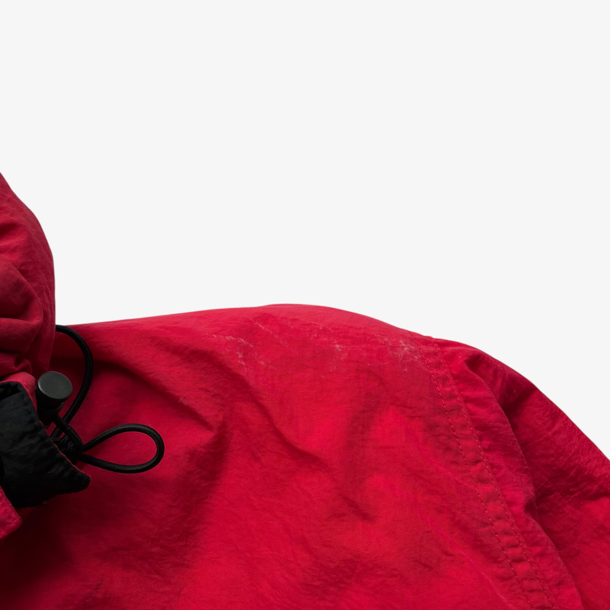 Wear on vintage 90s men's Marlboro country store red hooded puffer jacket.