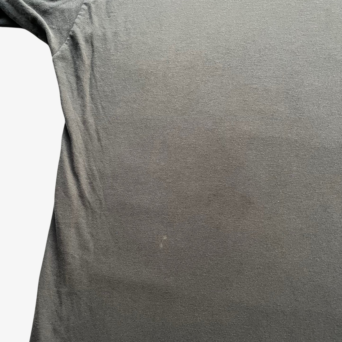 Patina on the back of men's vintage 90s Moschino Jeans no war but love cowboy print t-shirt.