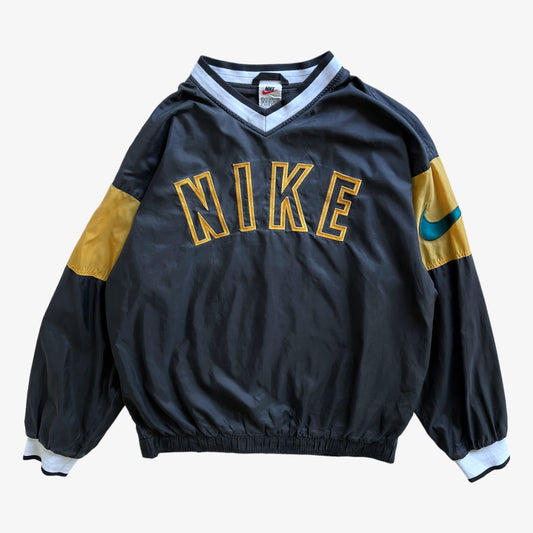 Vintage 90s men's Nike embroidered spell out grey v-neck pullover sweatshirt.
