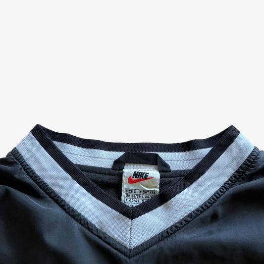 Vintage 90s Nike label stitched inside of men's embroidered spell out grey v-neck pullover sweatshirt.