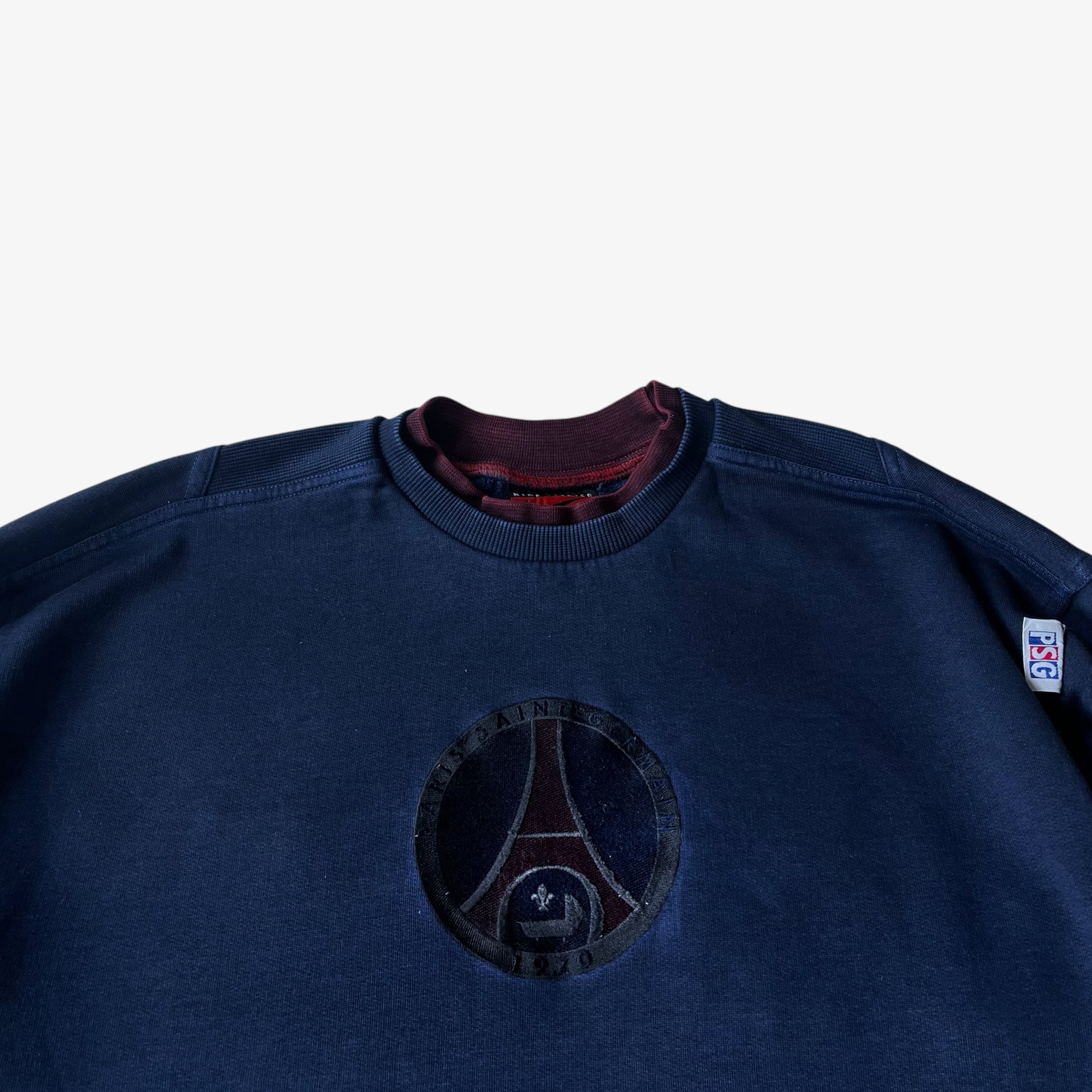 Close up of an embroidered PSG badge on a vintage Nike Premier sweatshirt.