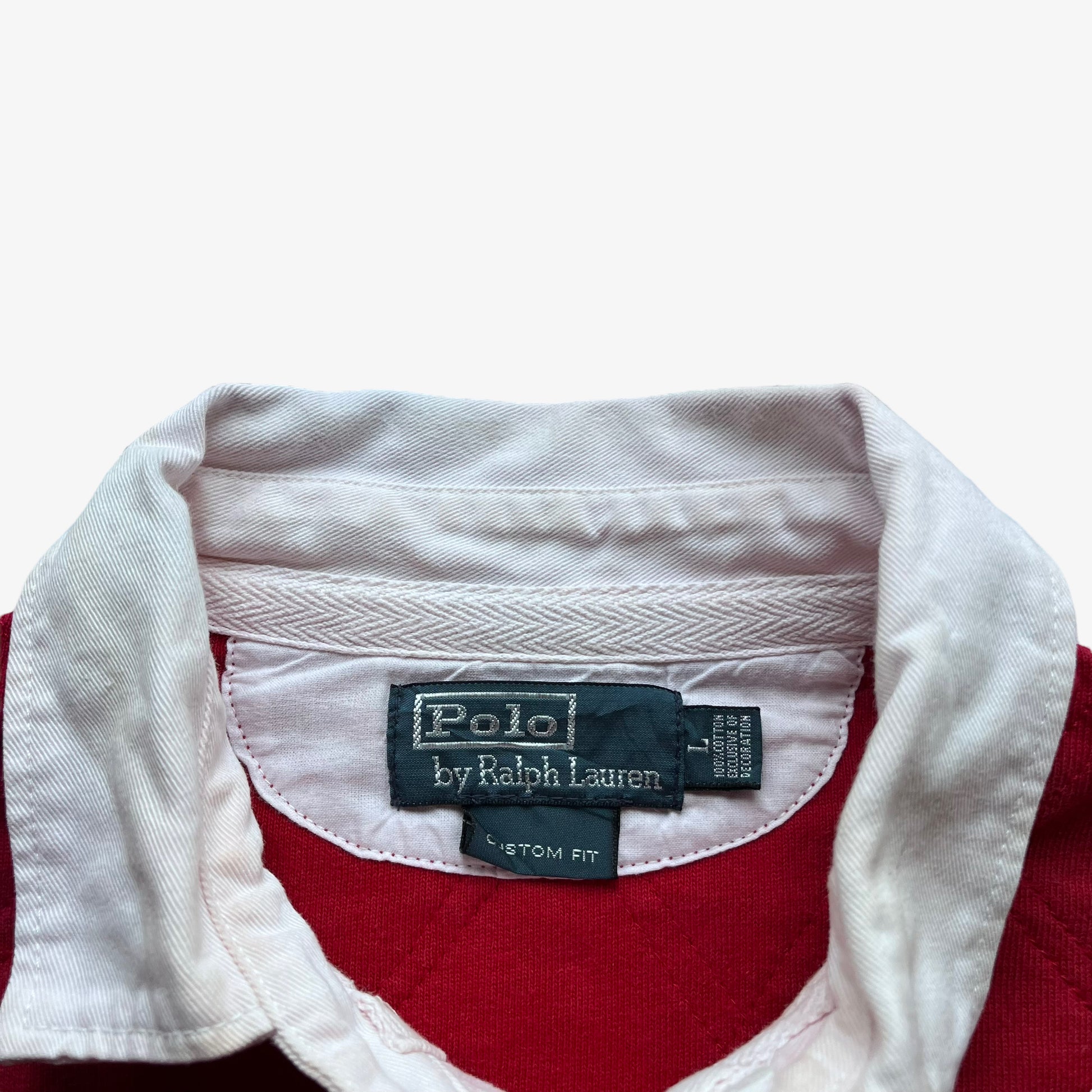 Polo Ralph Lauren label stitched inside of vintage 90s men's red rugby shirt with contrasting collar.