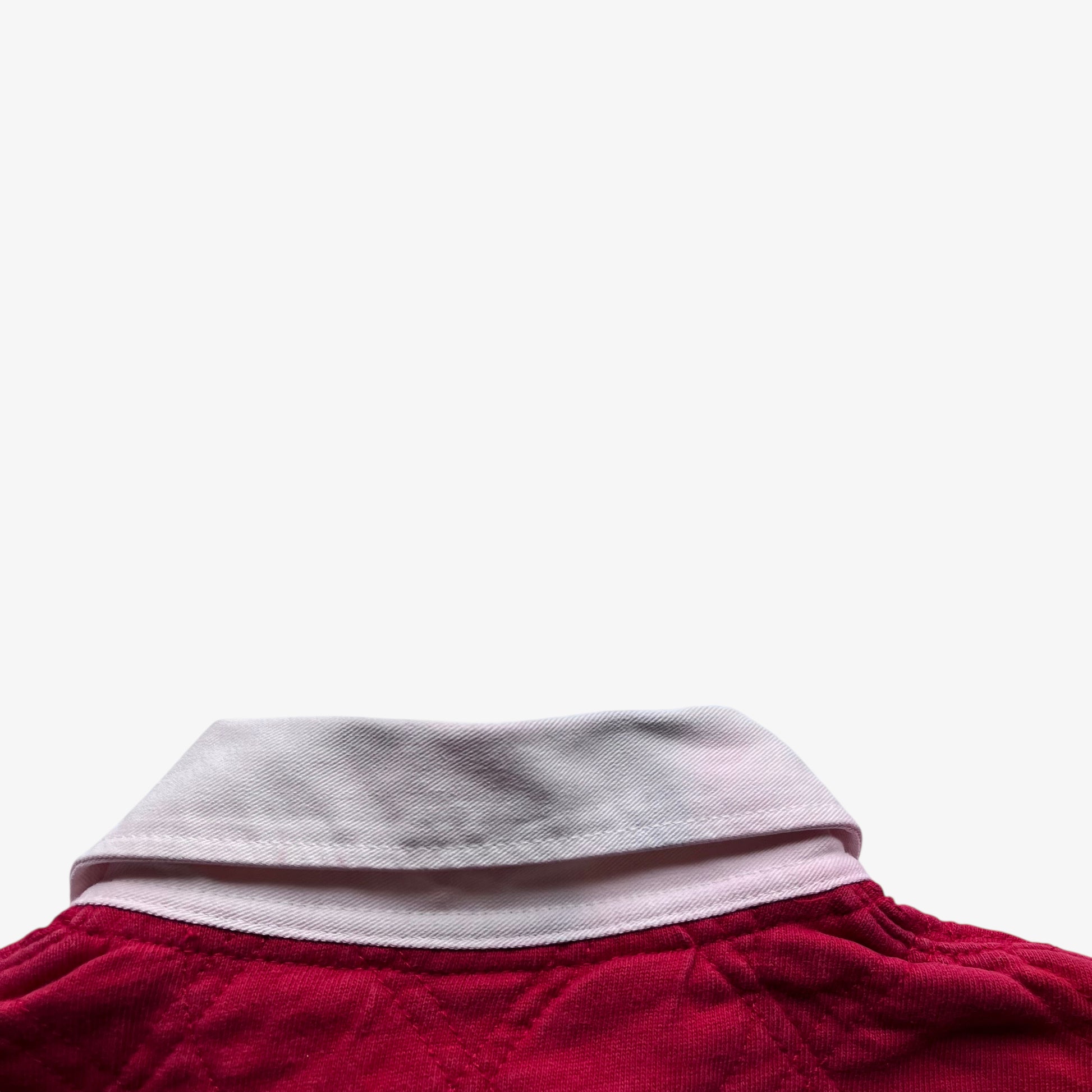 Patina on collar of vintage 90s men's Polo Ralph Lauren red rugby shirt.