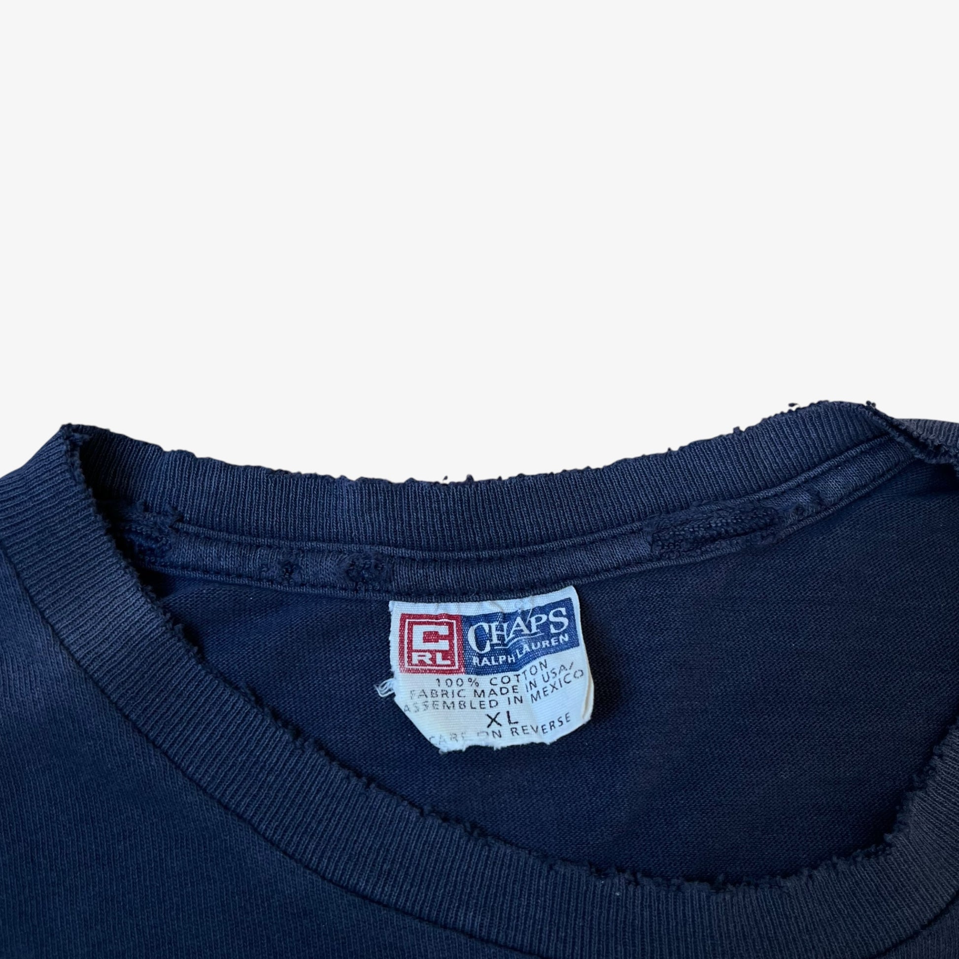 Vintage 90s Ralph Lauren Chaps label stitched inside a men's navy thrashed t-shirt.