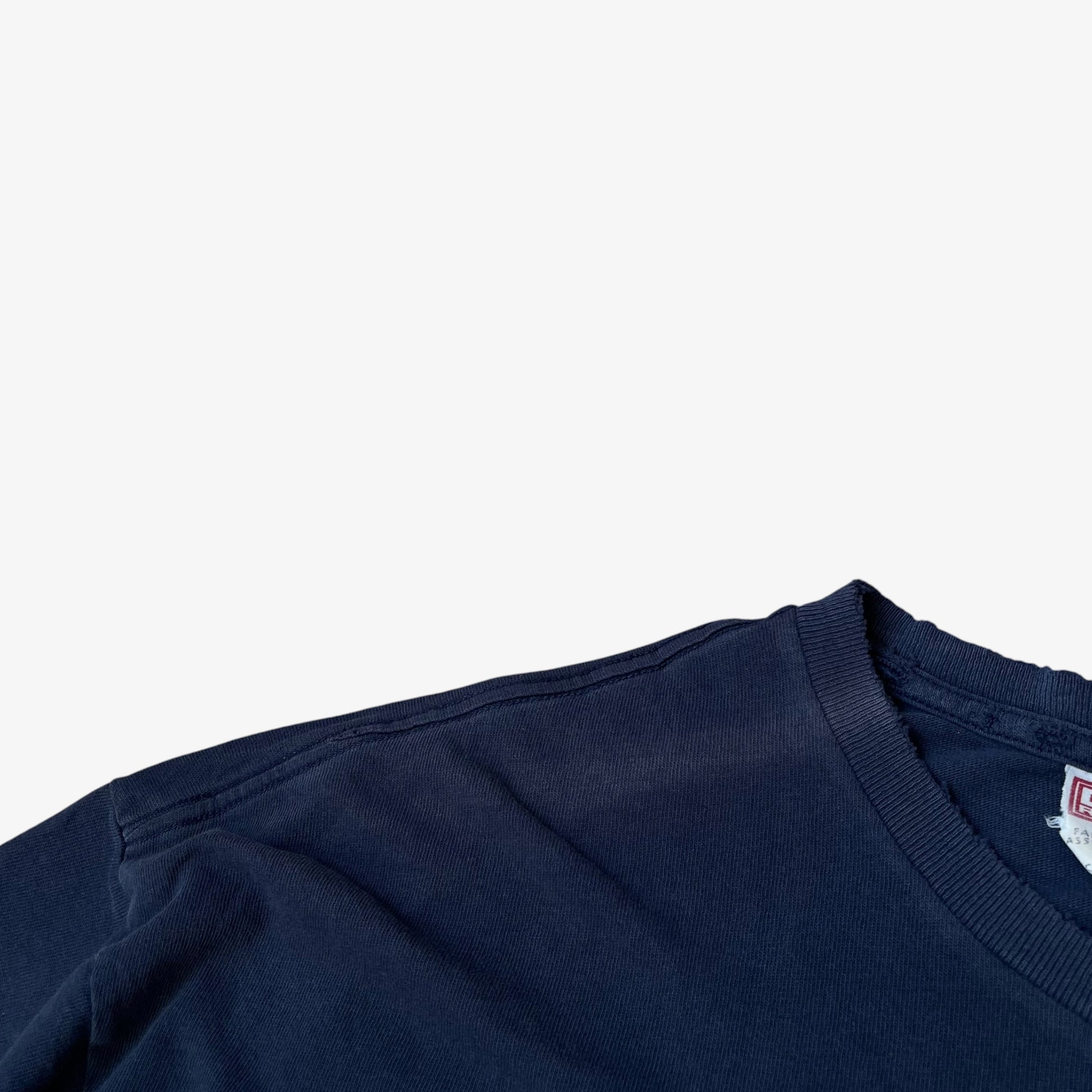 Faded shoulder on a vintage 90s men's thrashed navy t-shirt.