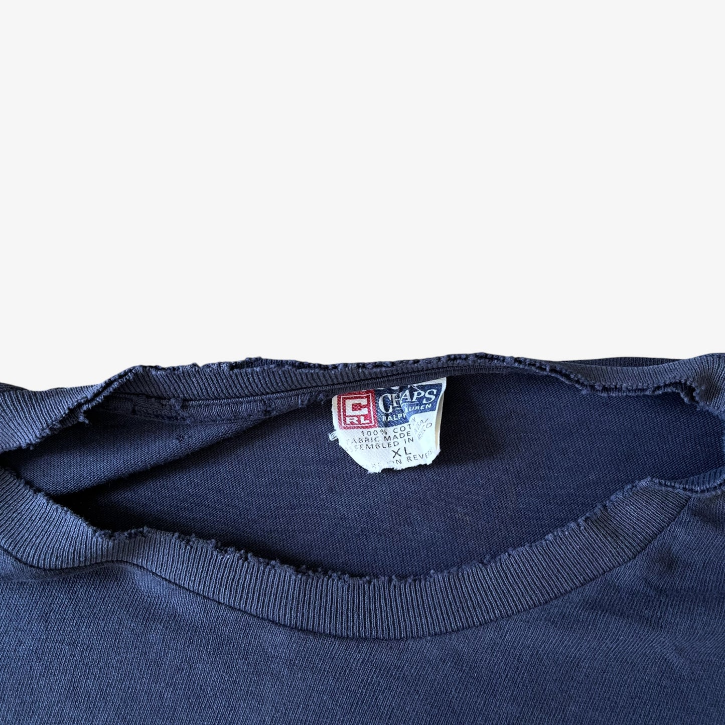 Thrashed collar of a vintage 90s men's Ralph Lauren Chaps navy t-shirt.