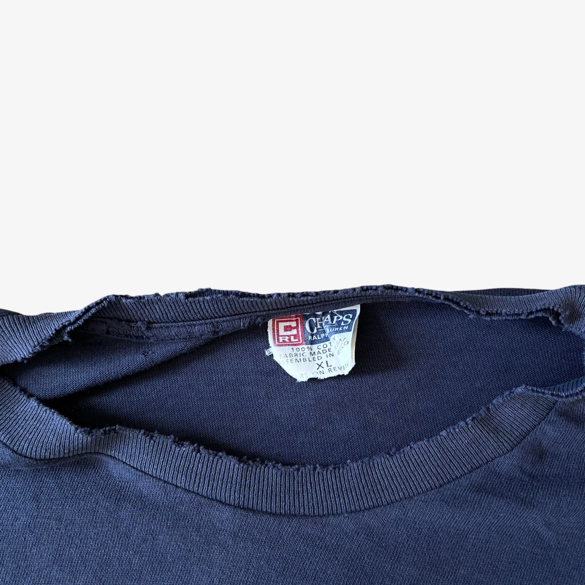 Thrashed collar of a vintage 90s men's Ralph Lauren Chaps navy t-shirt.