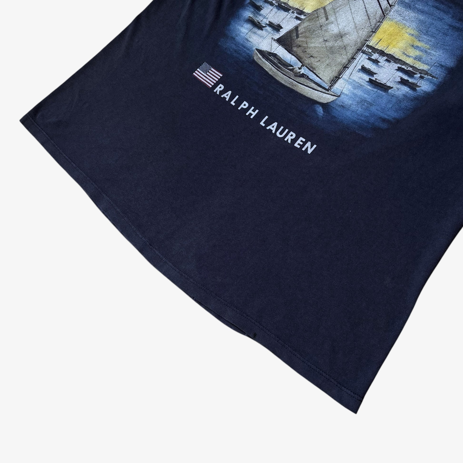 Hem of men's vintage 90s Ralph Lauren Chaps navy thrashed t-shirt.