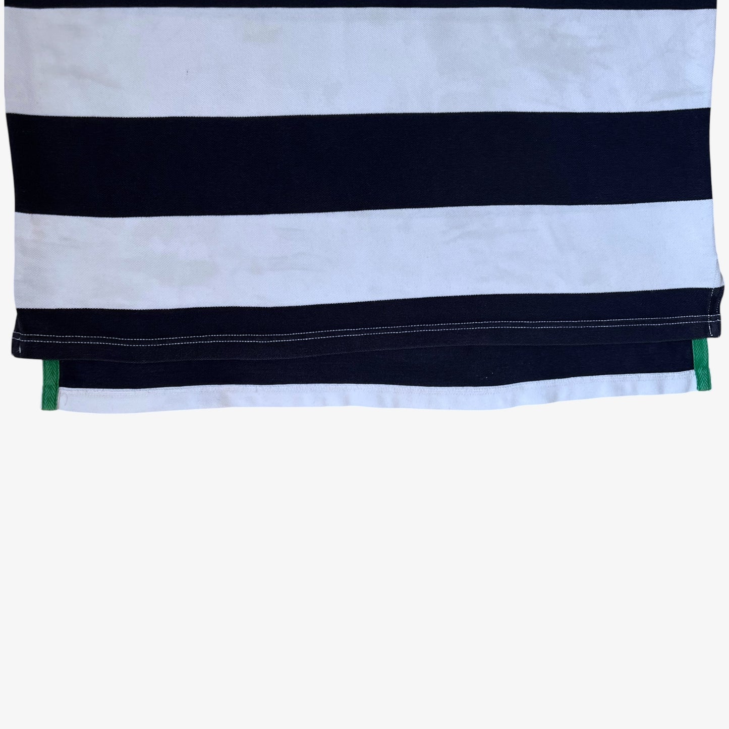 Hem of vintage 90s men's Ralph Lauren navy and white striped polo shirt.