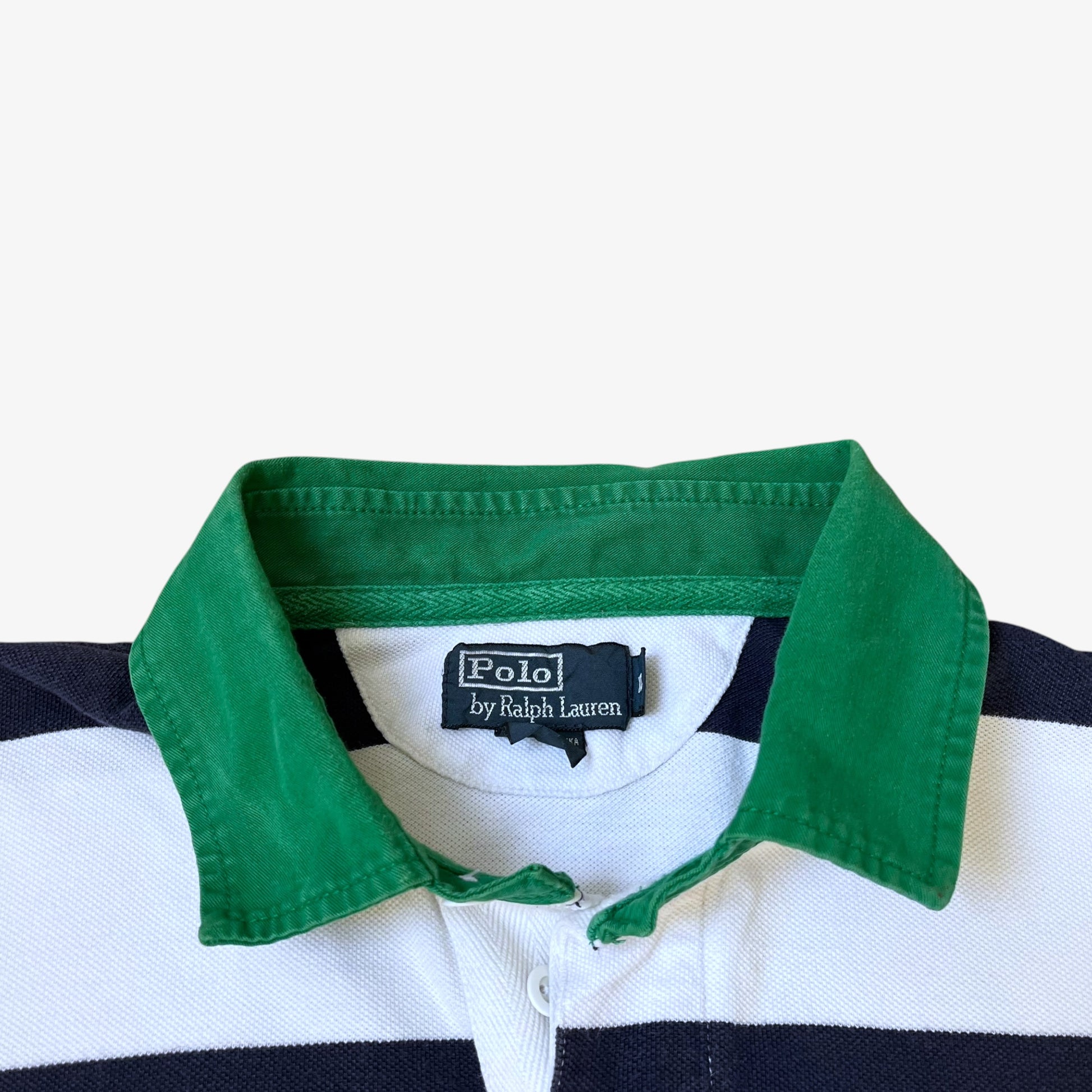 Vintage 90s Polo Ralph Lauren label stitched inside of a men's navy and white striped shirt with a contrasting green collar.