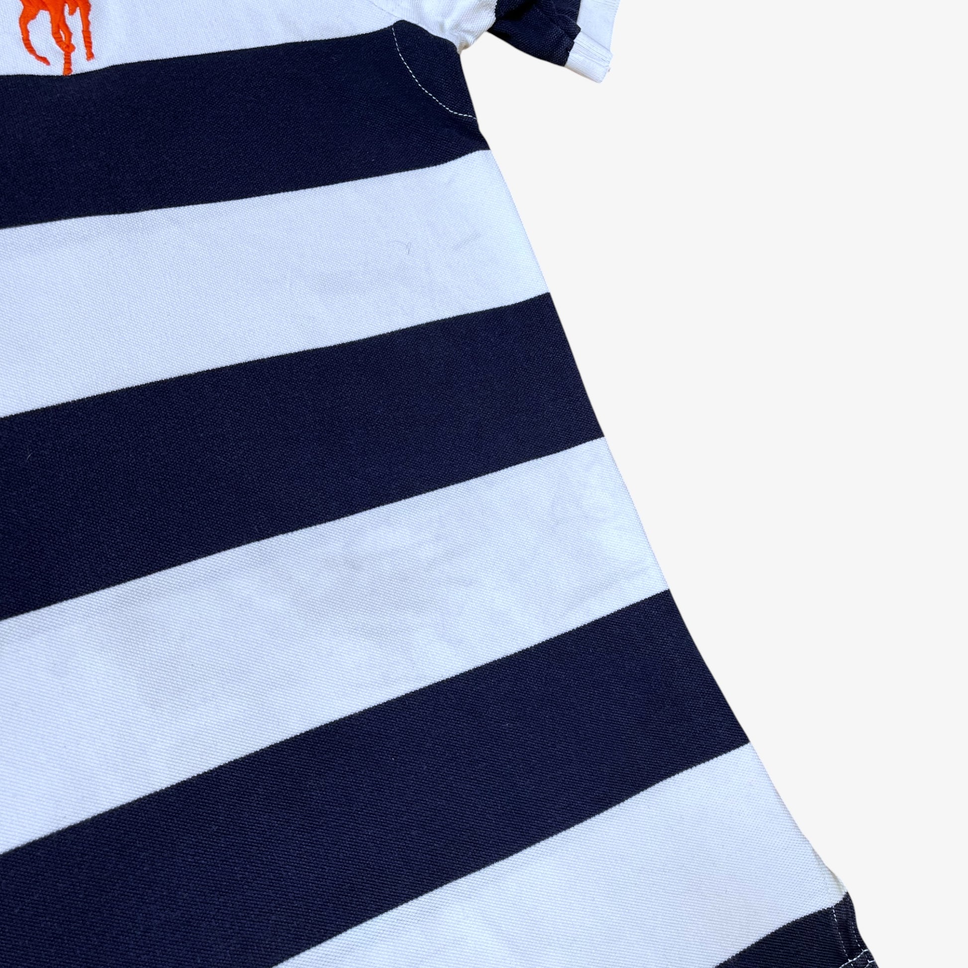 Close up of patina on vintage 90s men's Ralph Lauren navy and white striped polo shirt.