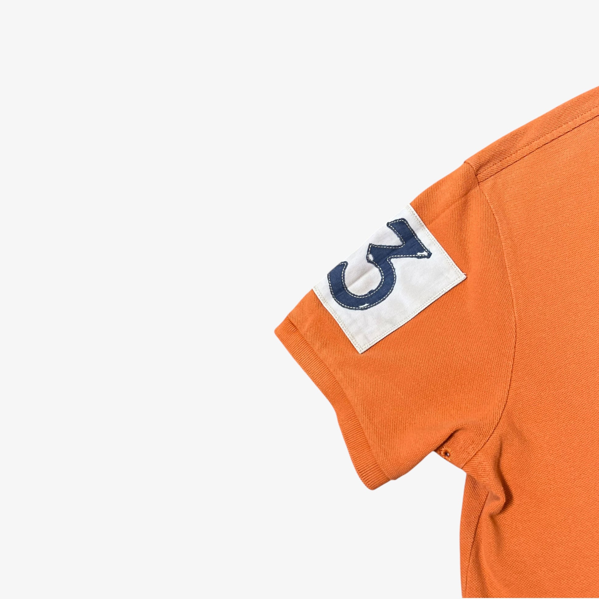 Number 3 badge on the sleeve of vintage Ralph Lauren orange rugby shirt.