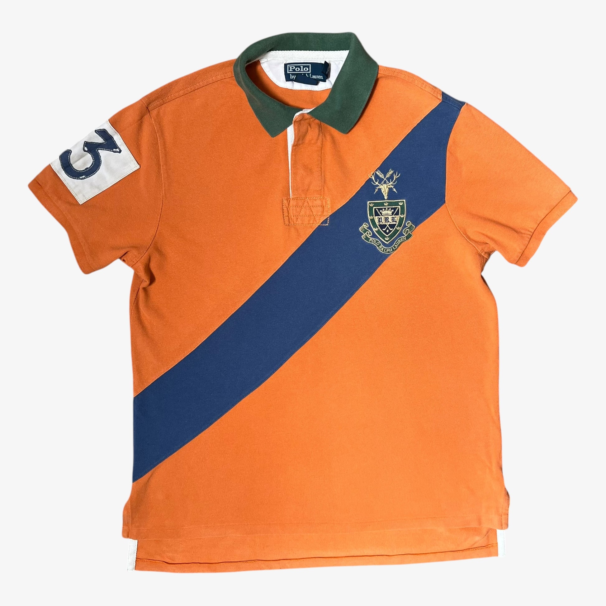 Vintage Ralph Lauren orange rugby shirt with blue diagonal stripe and logo on a white background.
