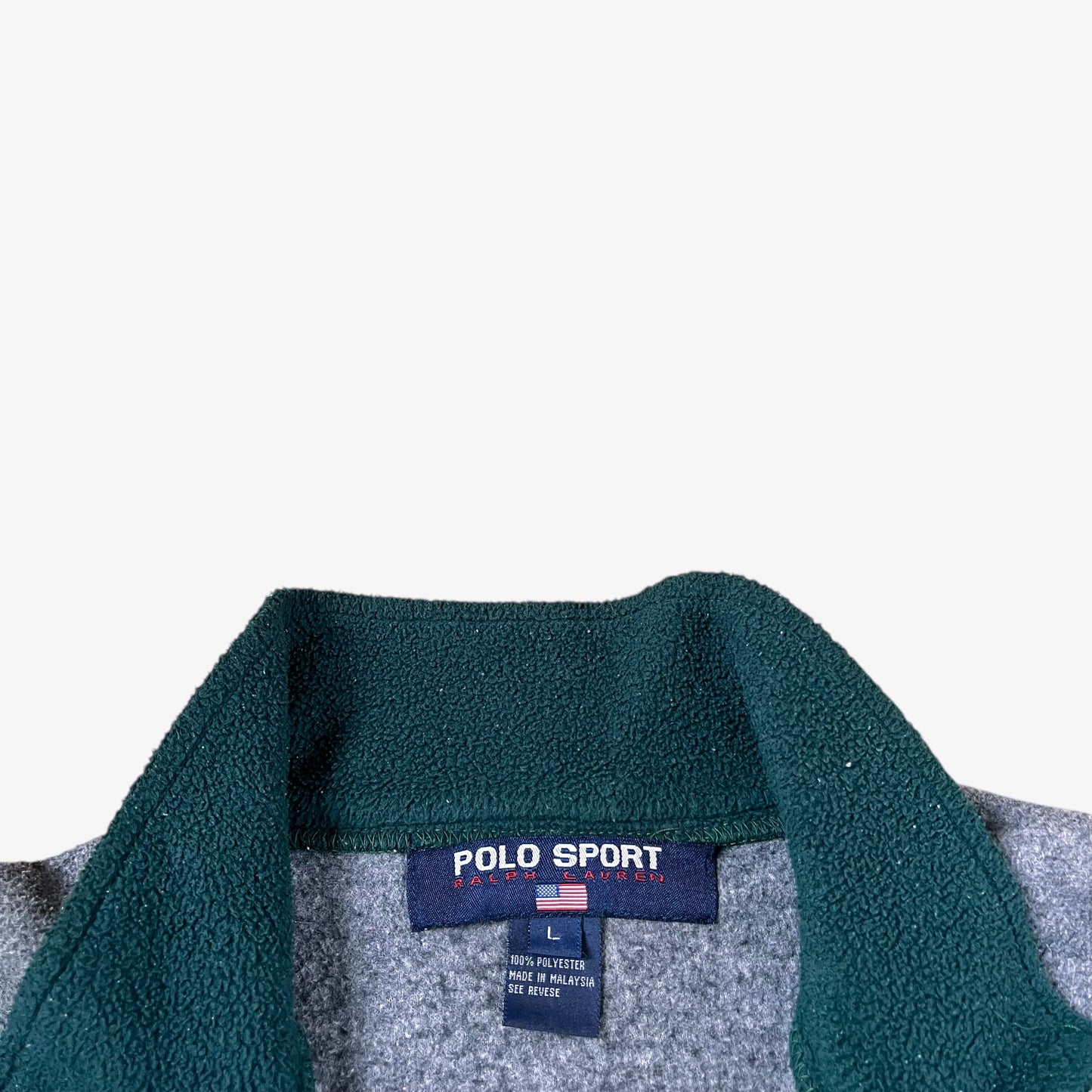 Close-up of a Ralph Lauren Polo Sport fleece collar with label on a white background