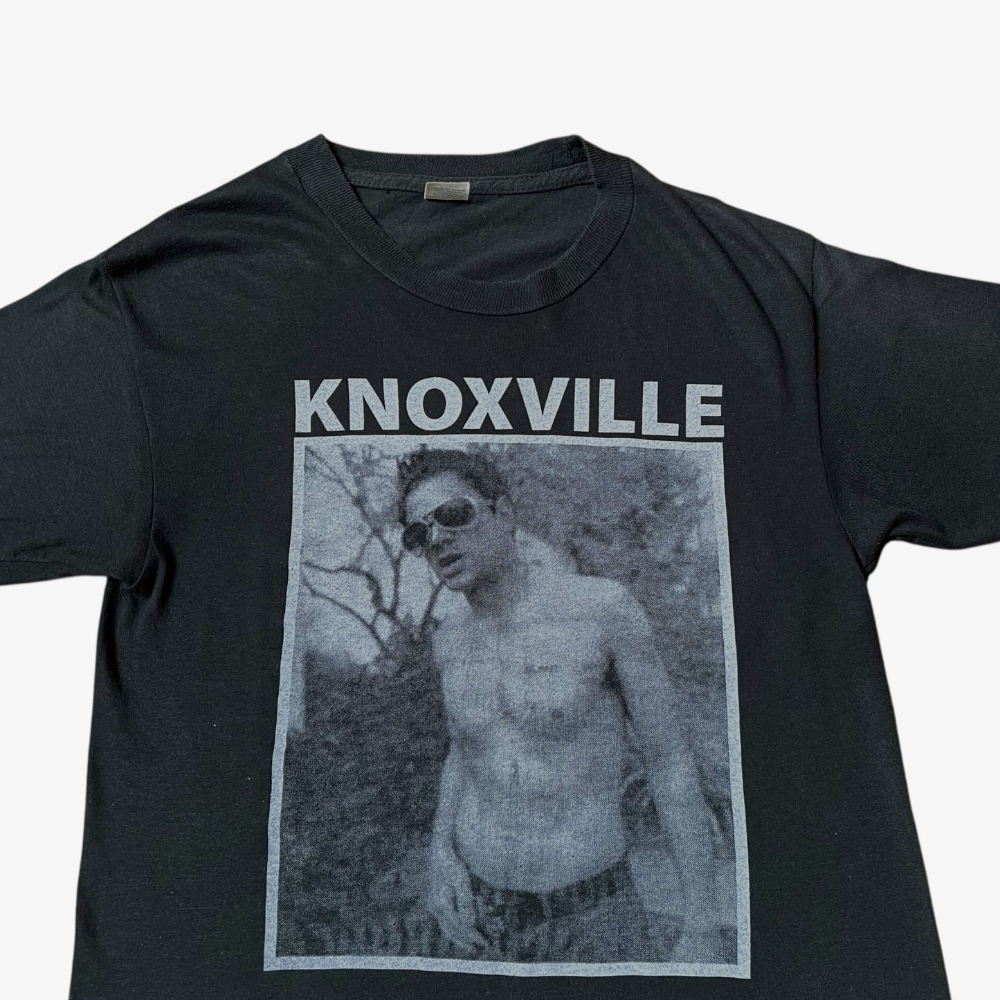Close up of MTV Jackass Johnny Knoxville print on a vintage 90s men's Screen Stars black single stitch t-shirt.