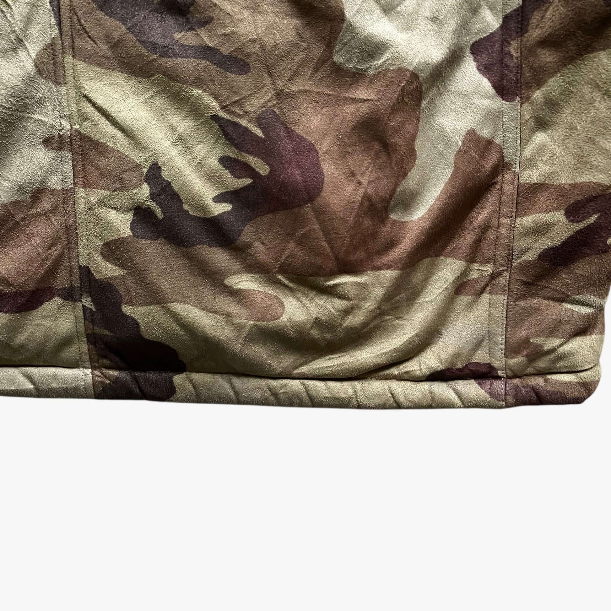 Hem of vintage 90s men's Sir Benni Miles green camouflage jacket featuring a faux fur hood.