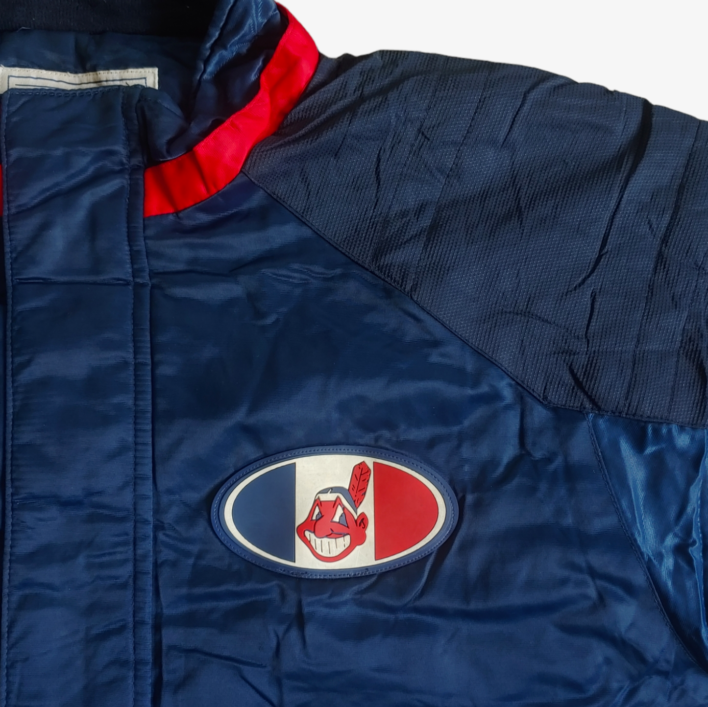 Badge on vintage Starter MLB Cleveland Indians jacket in blue with red and white accents.