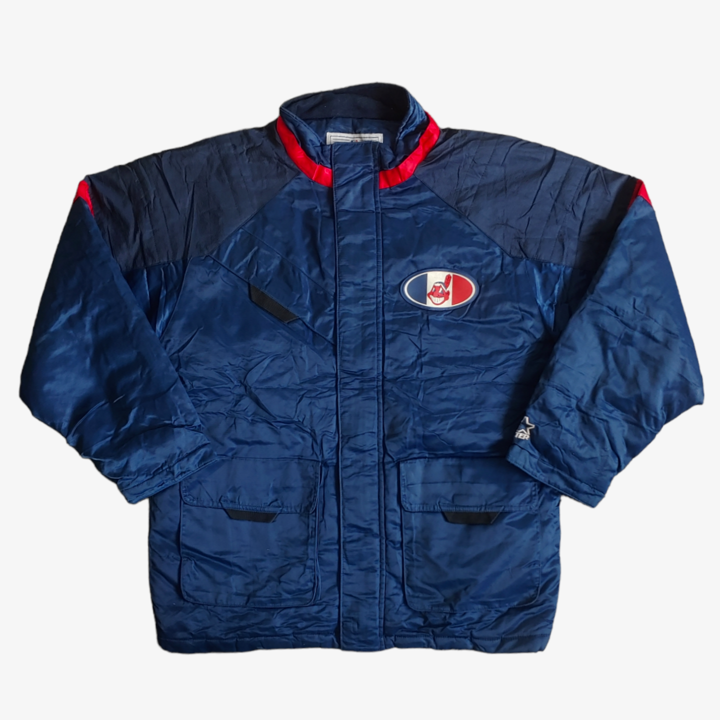 Vintage Starter MLB Cleveland Indians jacket in blue with red and white accents, featuring an embroidered logo on the back and a visible logo on the chest.
