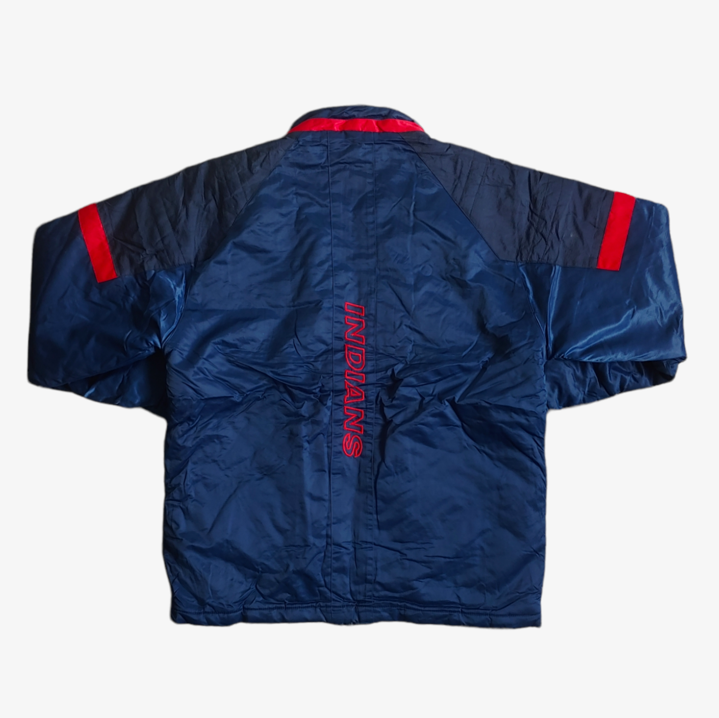 Back of vintage Starter MLB Cleveland Indians jacket in blue with red and white accents, featuring an embroidered logo.