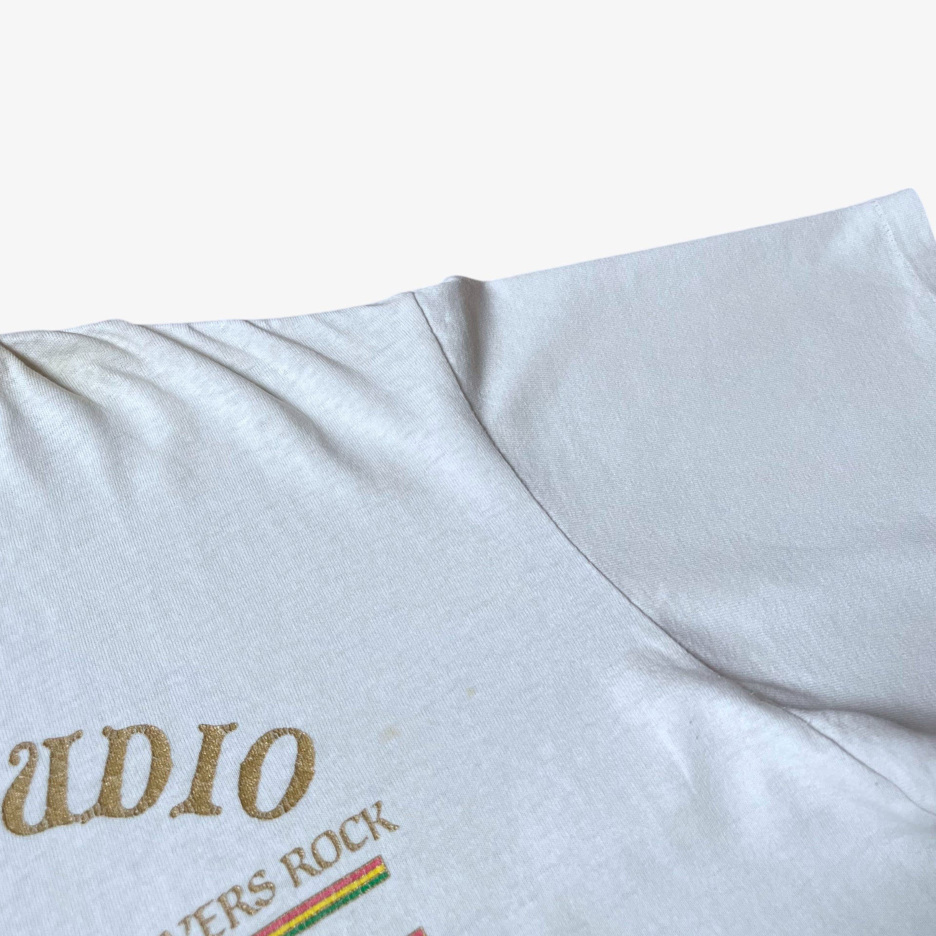 Sleeve patina on vintage 90s men's Stussy studio Jamaica reggae dance hall print white single stitch thrashed t-shirt.