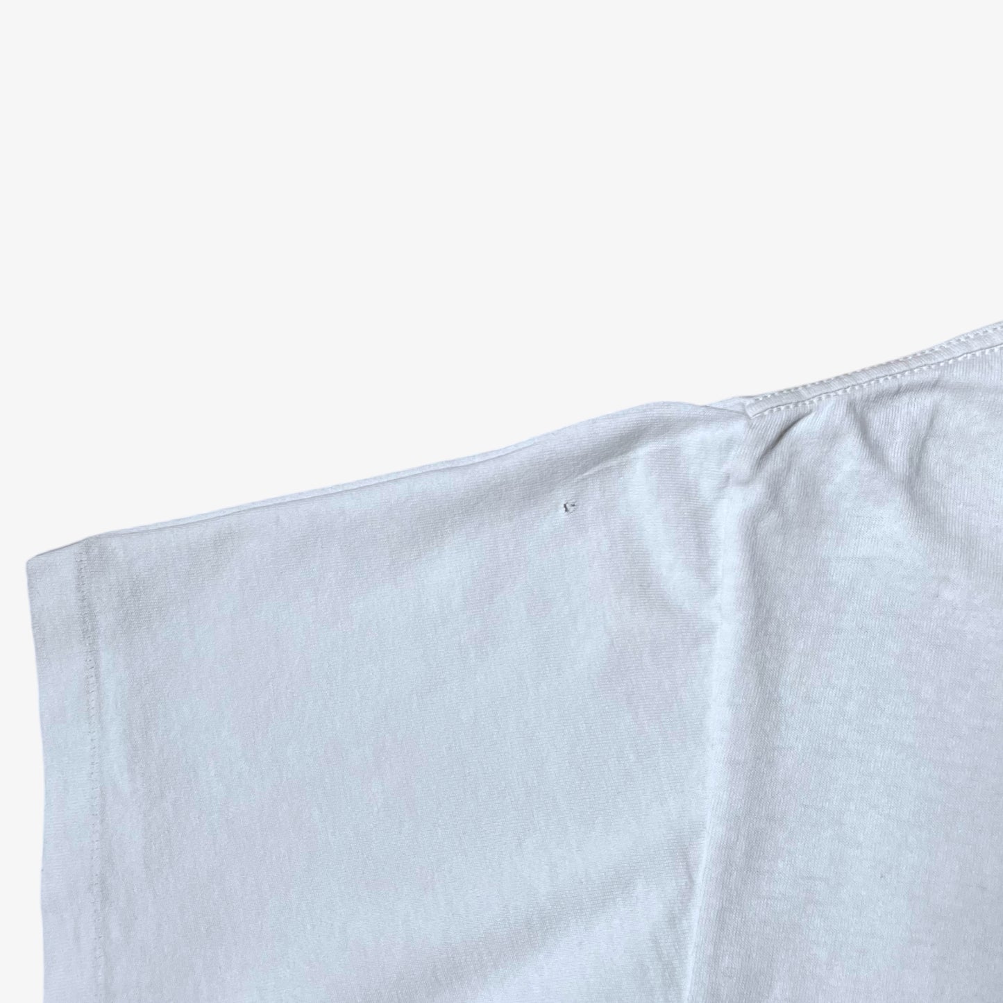 Sleeve wear on vintage 90s men's Stussy studio Jamaica reggae dance hall print white single stitch thrashed t-shirt.