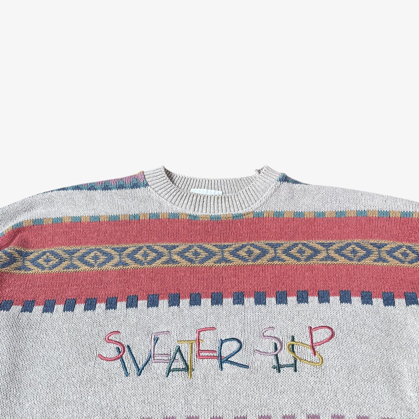 Sweater with colourful pattern and 'Sweater Shop' text on a white background