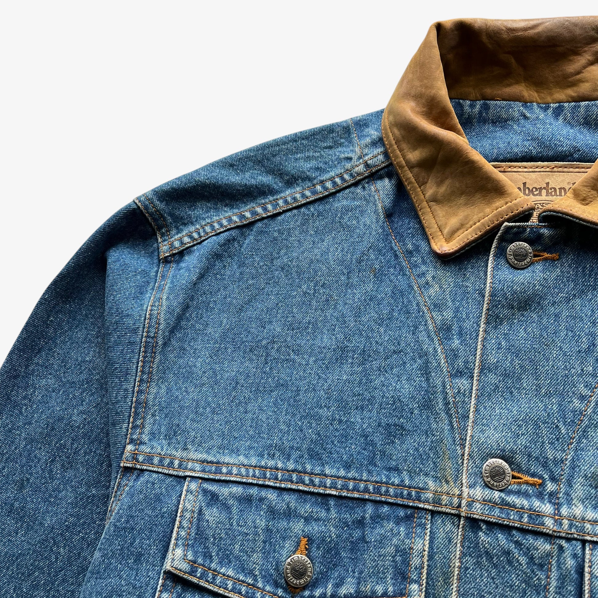 Faded colour on men's vintage 90s Timberland blue denim jacket with leather collar and Looney Tunes Marvin Martian print.