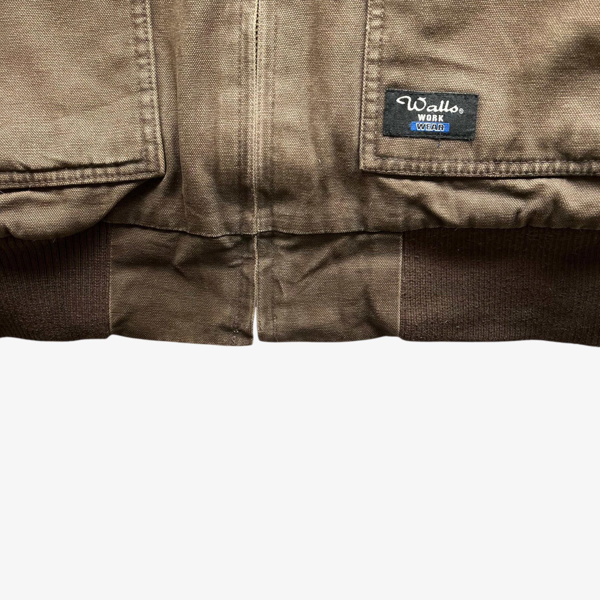 Walls workwear tag embroidered on the hem of vintage 90s men's brown hooded chore jacket.