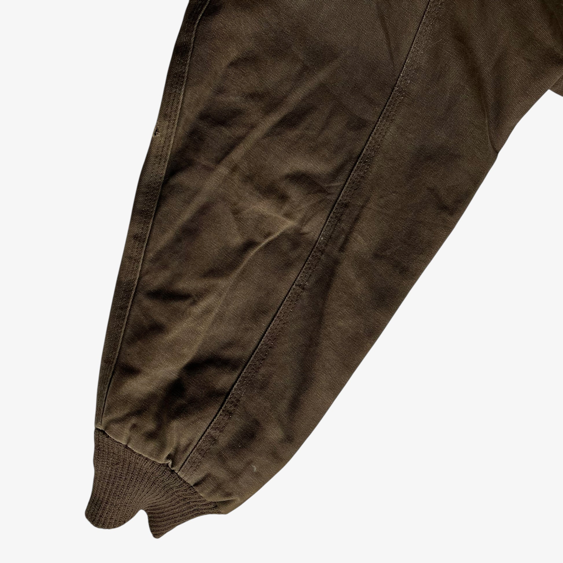 General wear on sleeve of vintage 90s men's Walls brown hooded workwear jacket.