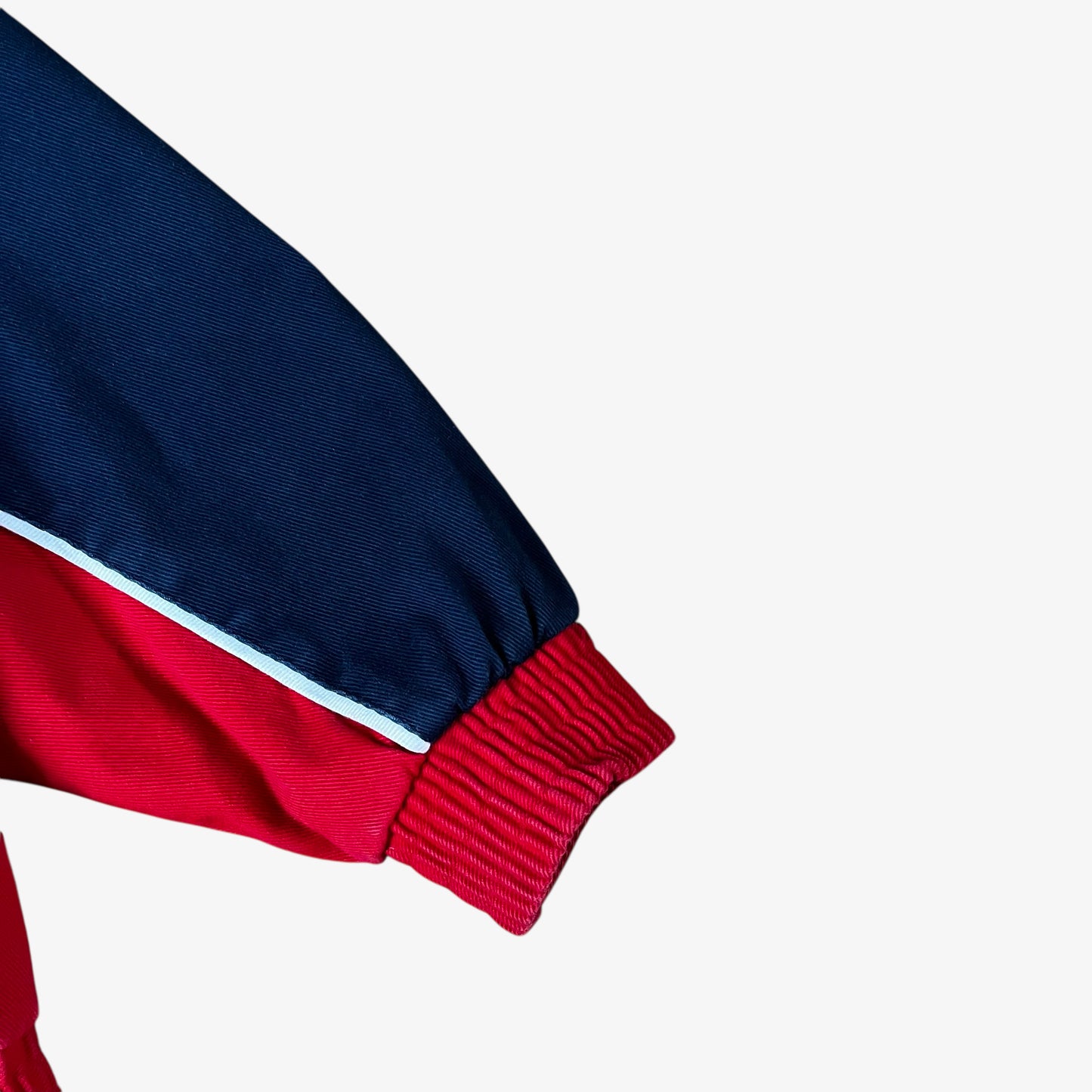 Cuff of vintage 90s Winner’s Circle Budweiser navy and red NASCAR jacket.