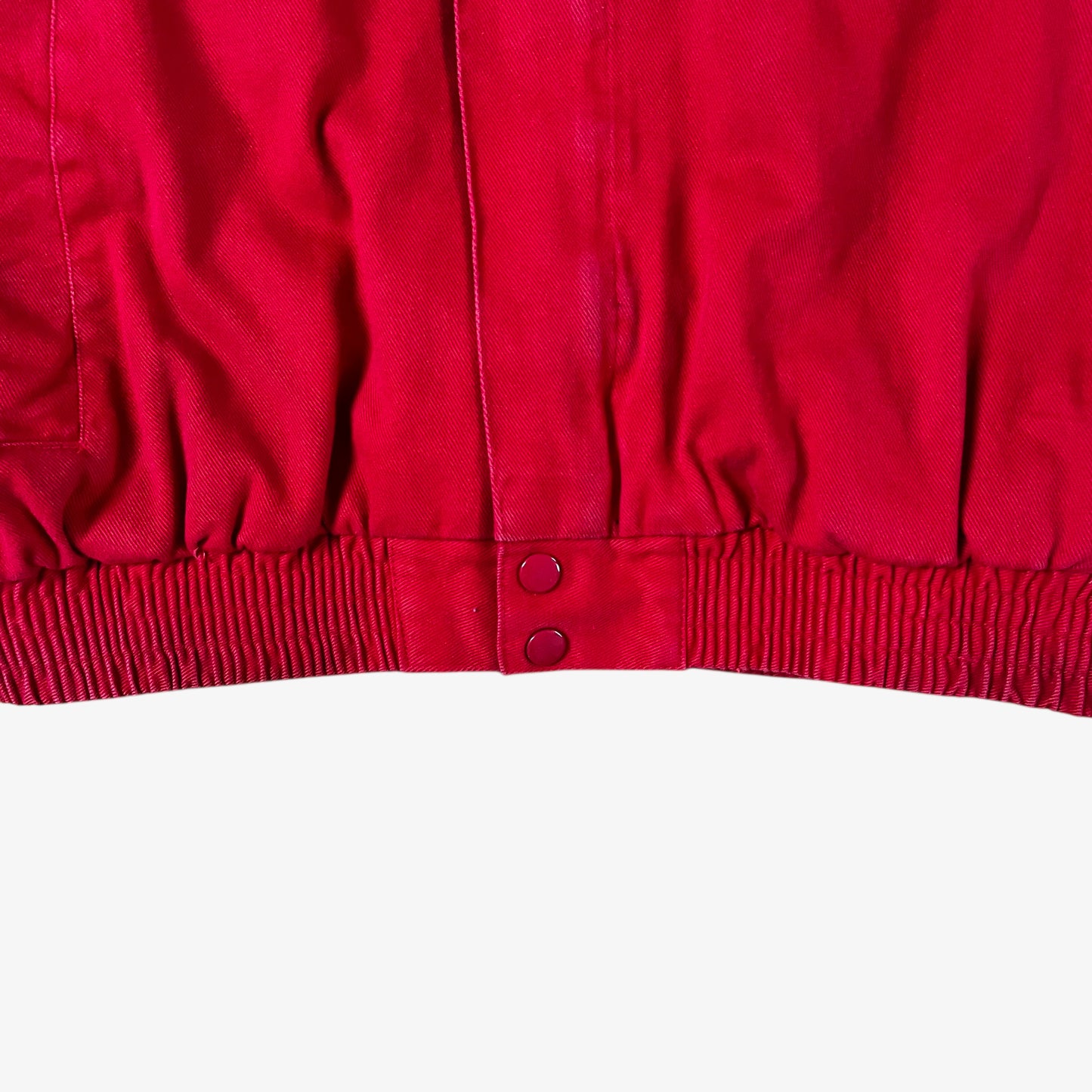 Hem of vintage 90s Winner’s Circle Budweiser navy and red NASCAR jacket.