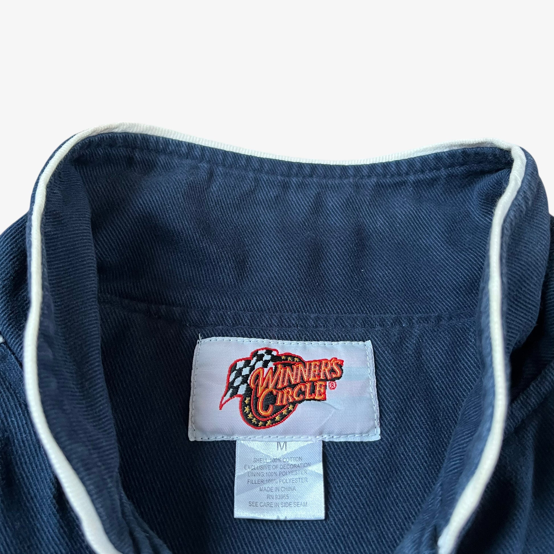 Label of vintage 90s Winner’s Circle Budweiser navy and red NASCAR jacket.