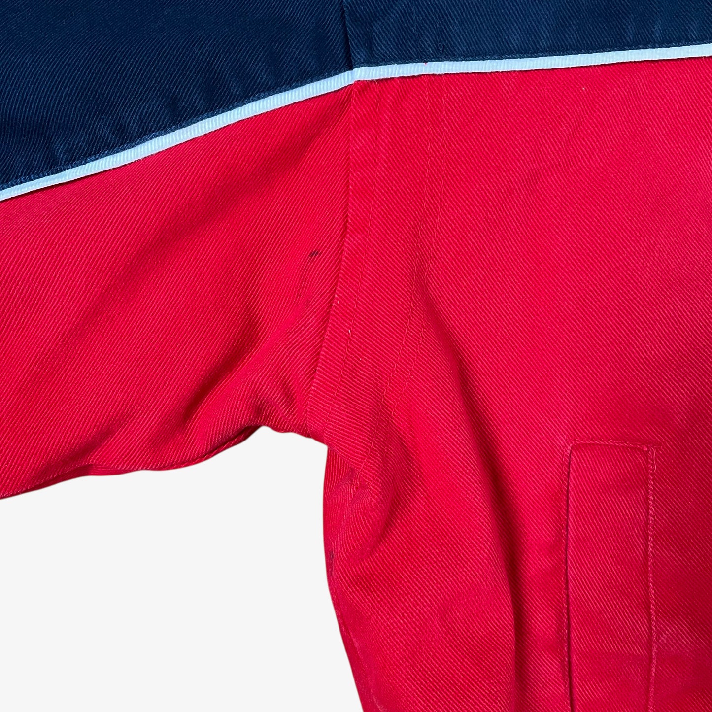 Scuff on sleeve of vintage 90s Winner’s Circle Budweiser navy and red NASCAR jacket.