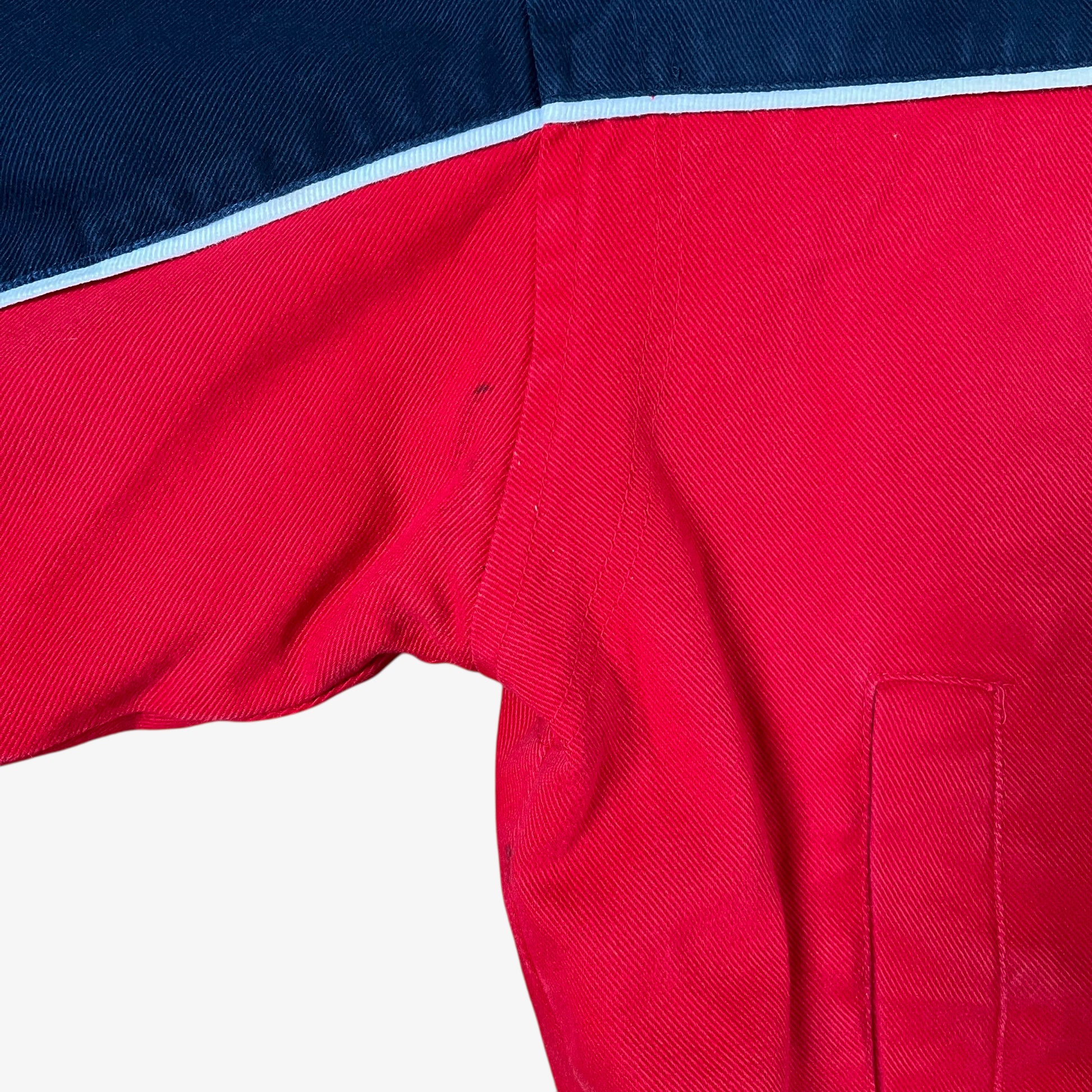 Scuff on sleeve of vintage 90s Winner’s Circle Budweiser navy and red NASCAR jacket.