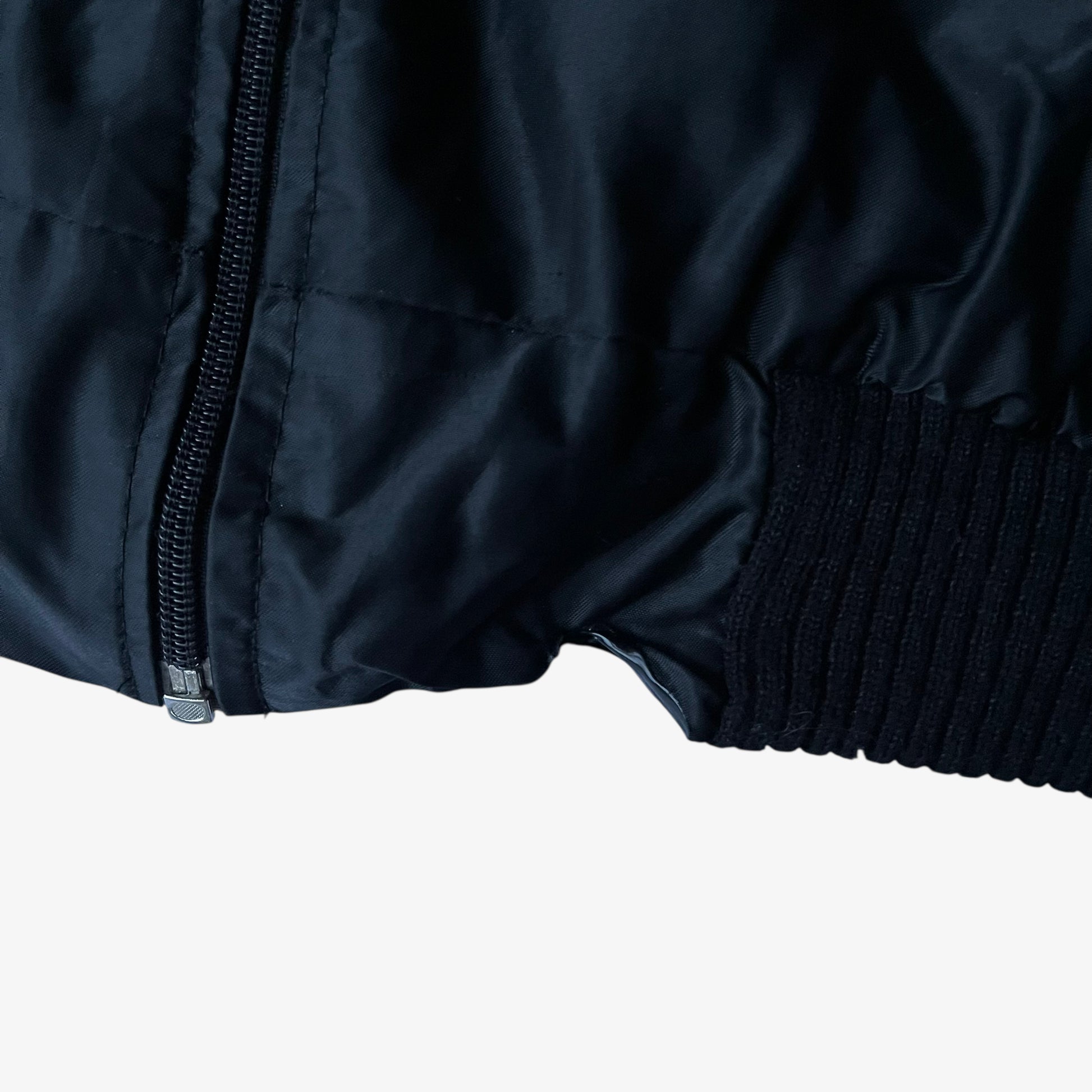 Hem of vintage 90s men's Zip It black panther print bomber jacket.