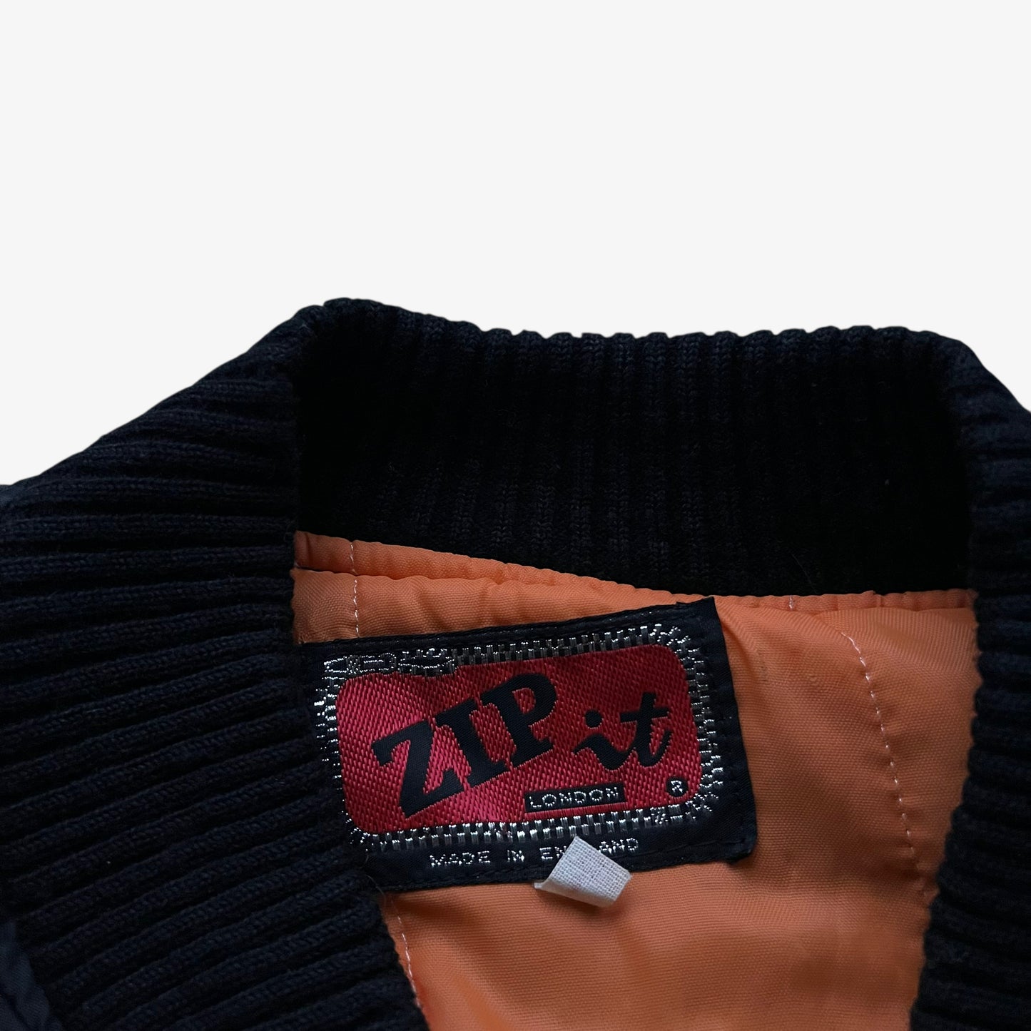 Zip It label stitched inside of vintage 90s men's Zip It black panther print bomber jacket.