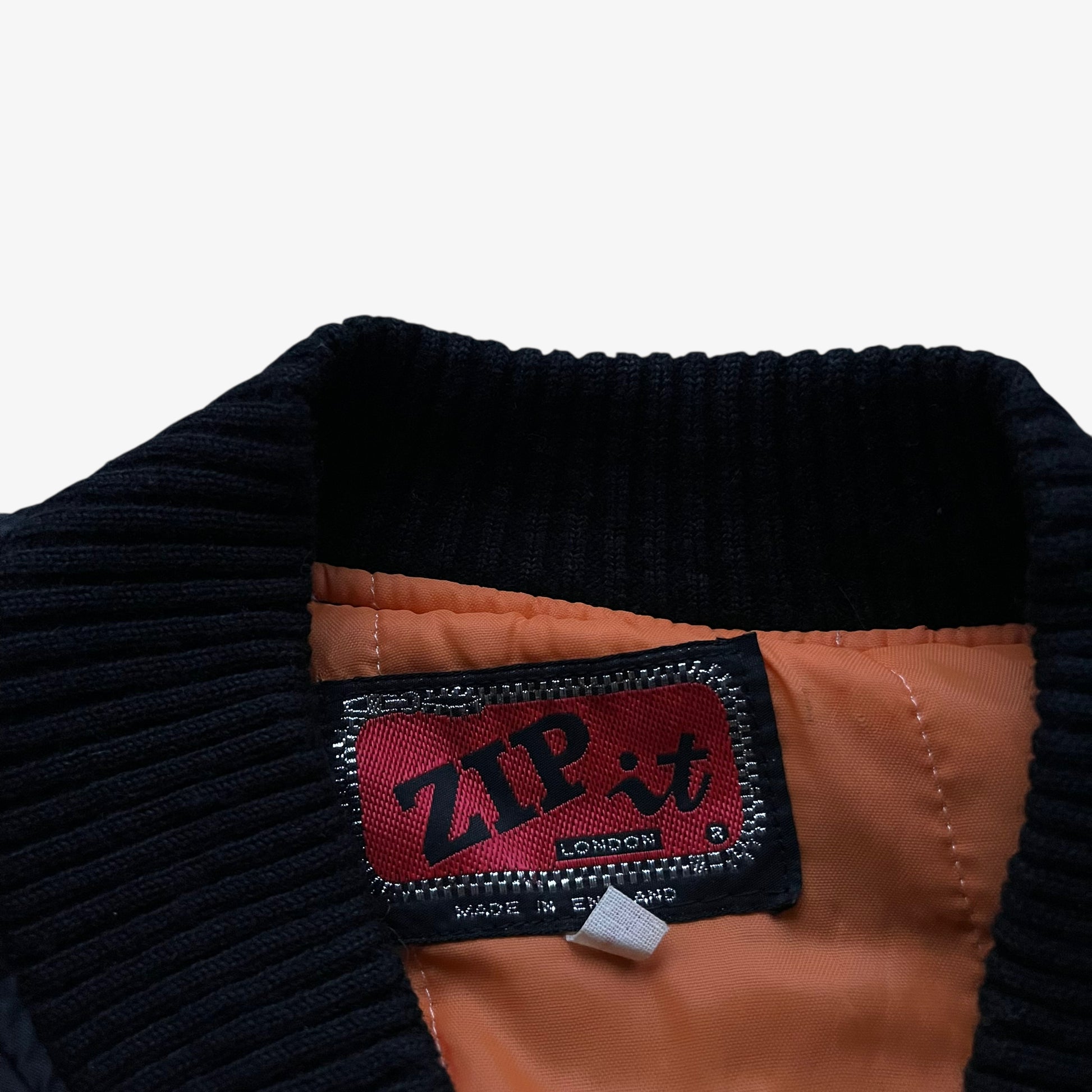 Zip It label stitched inside of vintage 90s men's Zip It black panther print bomber jacket.