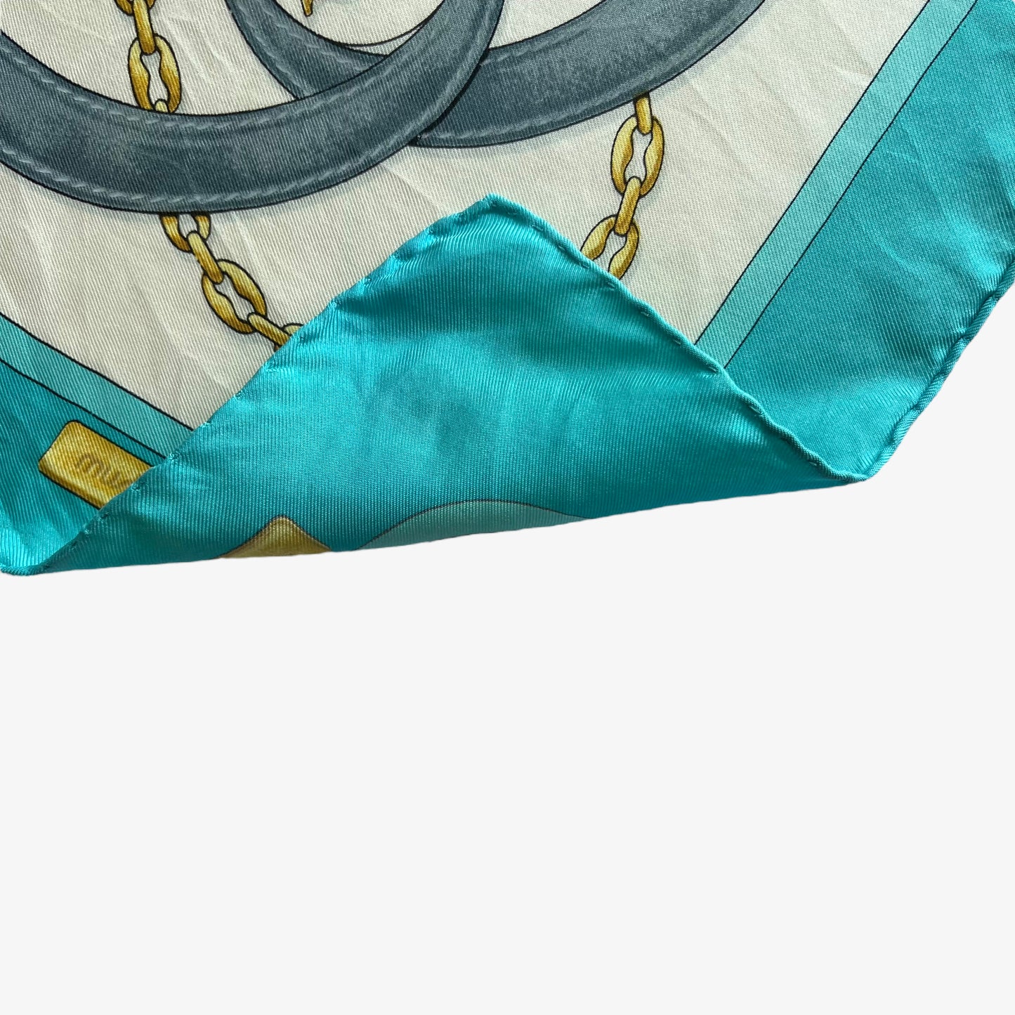 Hand rolled edges of women's vintage 90s must de Cartier equestrian strap print blue silk scarf featuring the classic CC logo.